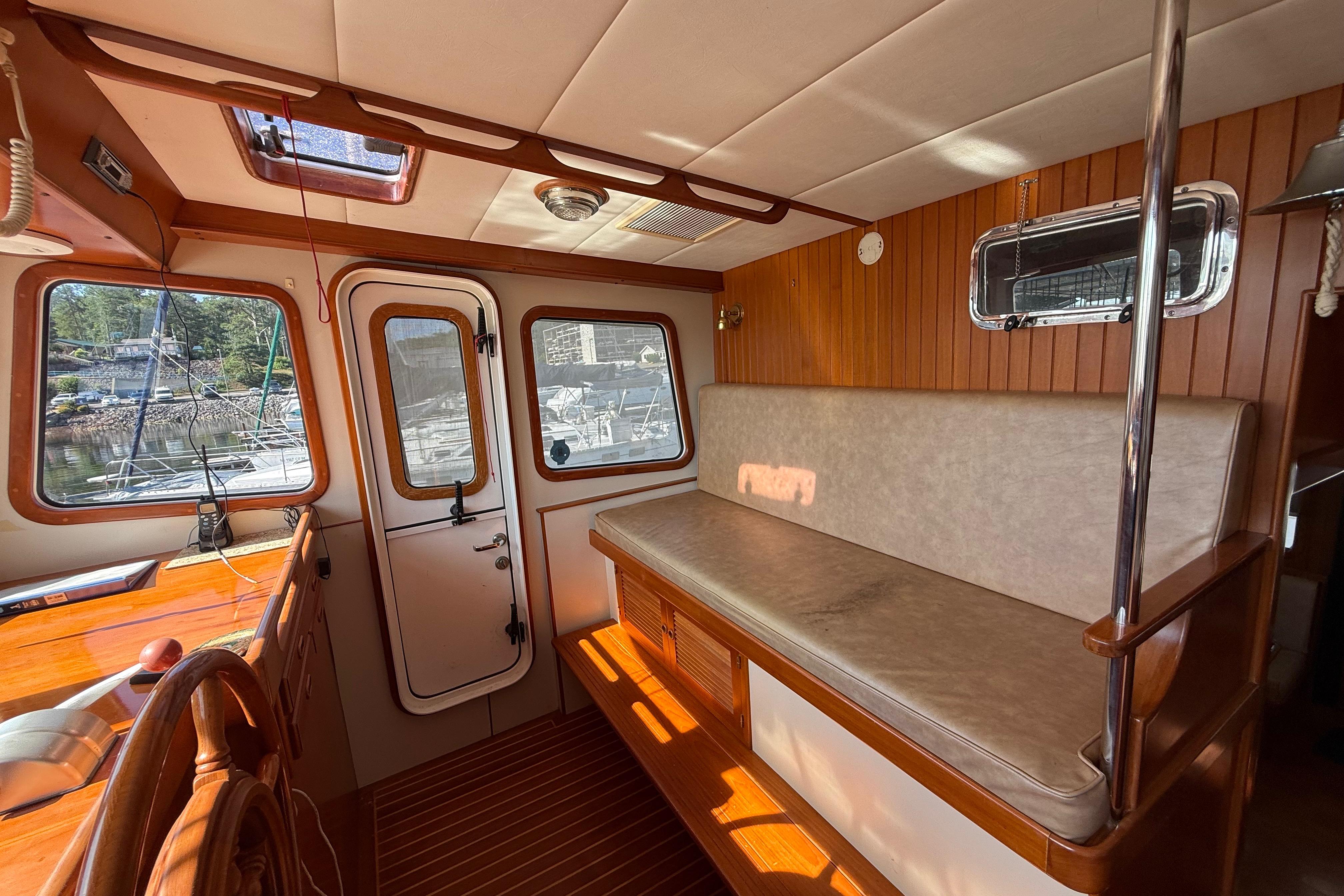 Interior of 2001 Kadey-Krogen 39 boat with wooden accents and seating area.