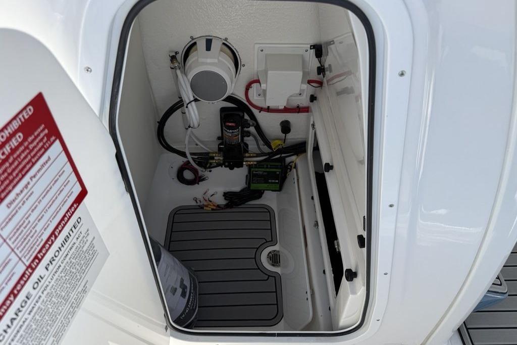 Interior compartment of 2026 Tidewater 232 LXF boat, showing equipment and wiring.