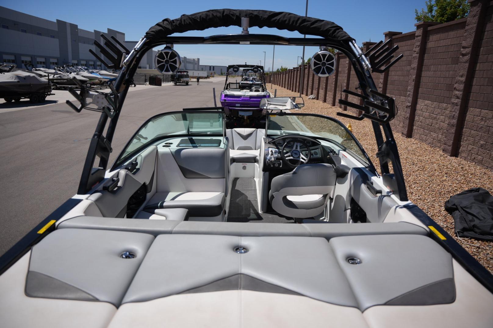 Interior view of a 2016 Supreme S211 boat, showcasing seating and dashboard features.