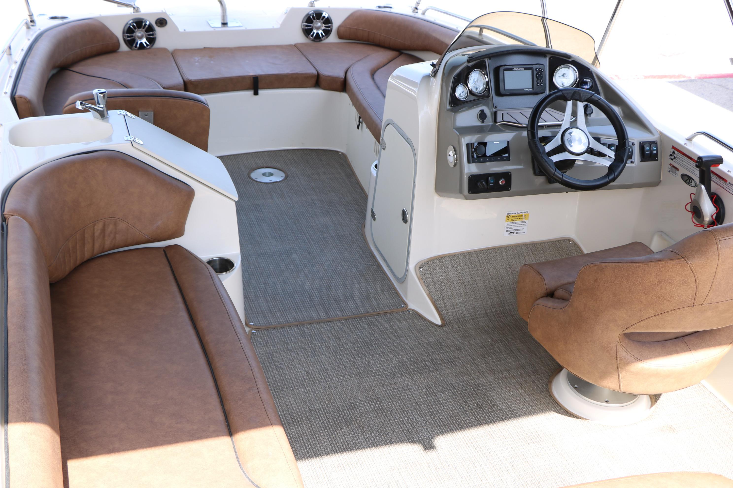 2022 Stingray 192 SC boat interior with brown seating and modern dashboard.
