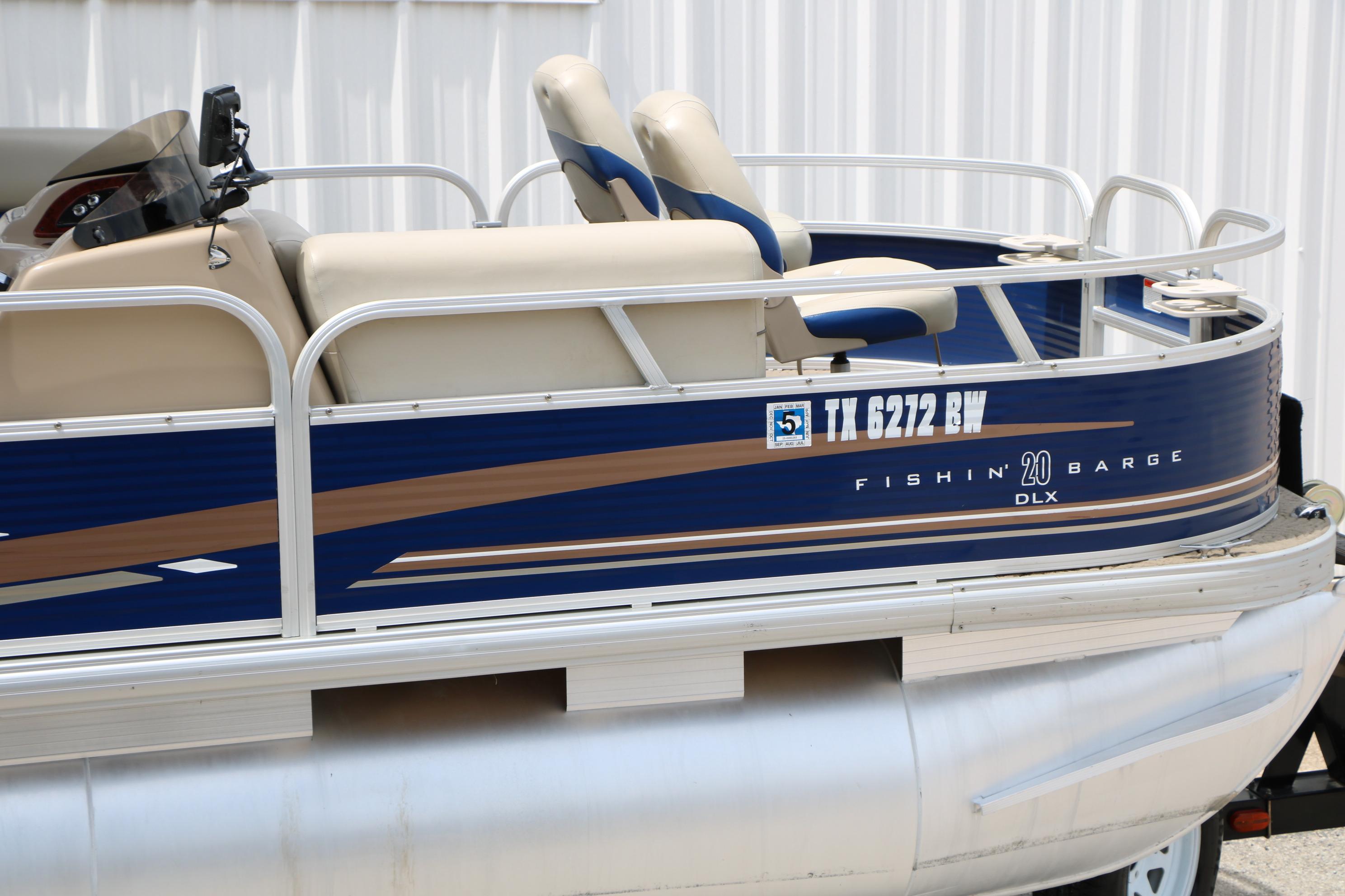 2013 Sun Tracker Fishin' Barge 20 DLX pontoon boat with beige seating and blue exterior.