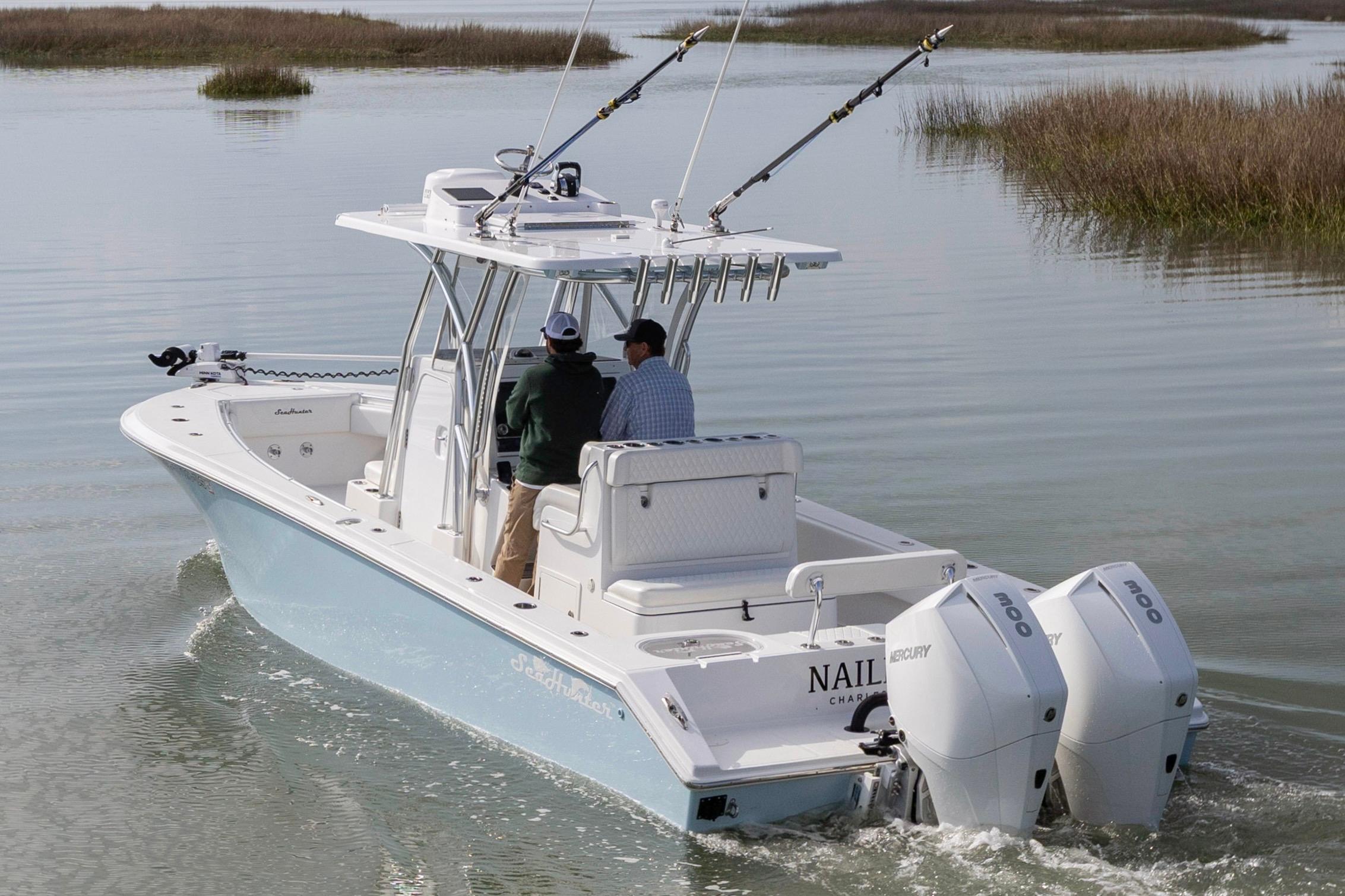 2021 SeaHunter 28 Floridian boat with dual Mercury engines navigating calm waters.