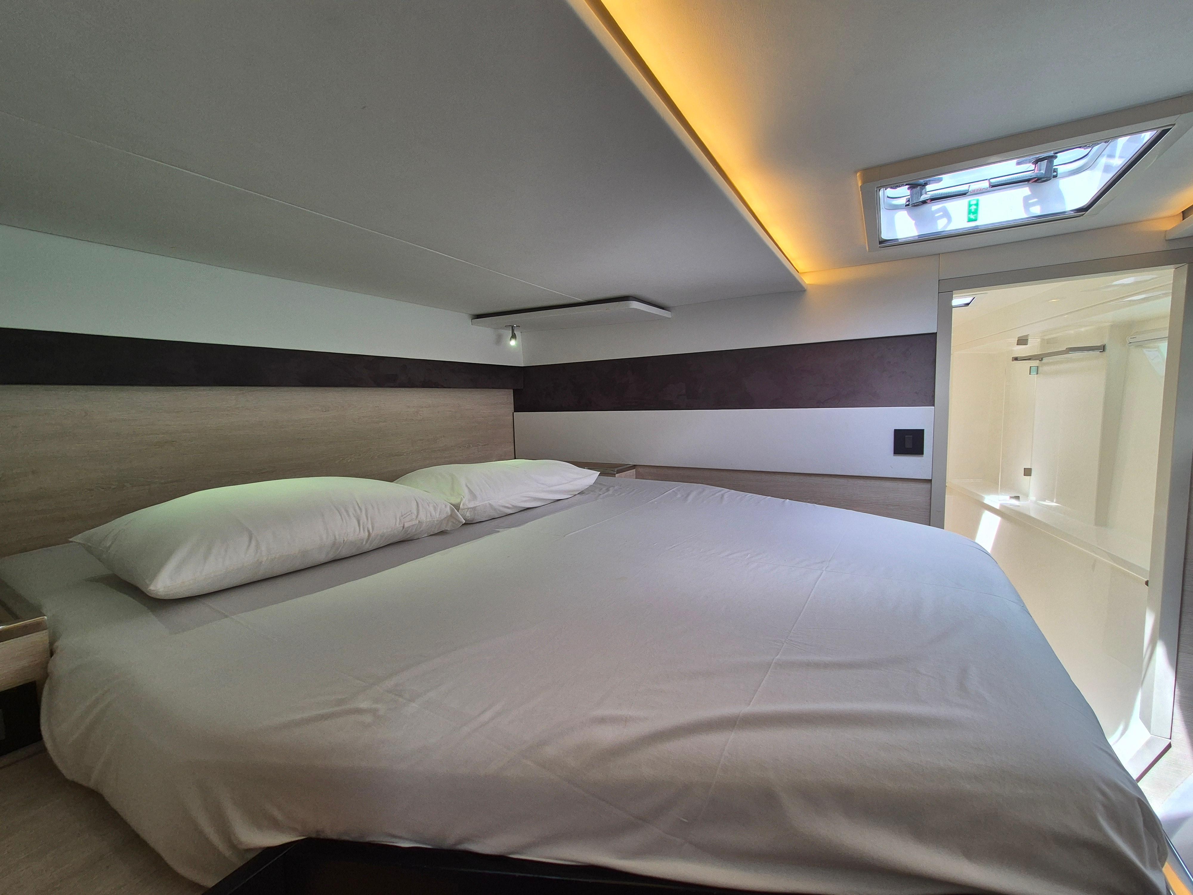 Luxurious bedroom interior in a 2020 Leopard 50 yacht, featuring a spacious bed and modern design.