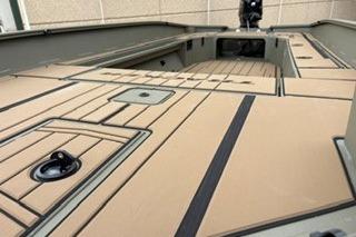 2026 Tracker Grizzly 1756 T Marsh boat interior with tan decking and storage compartments.