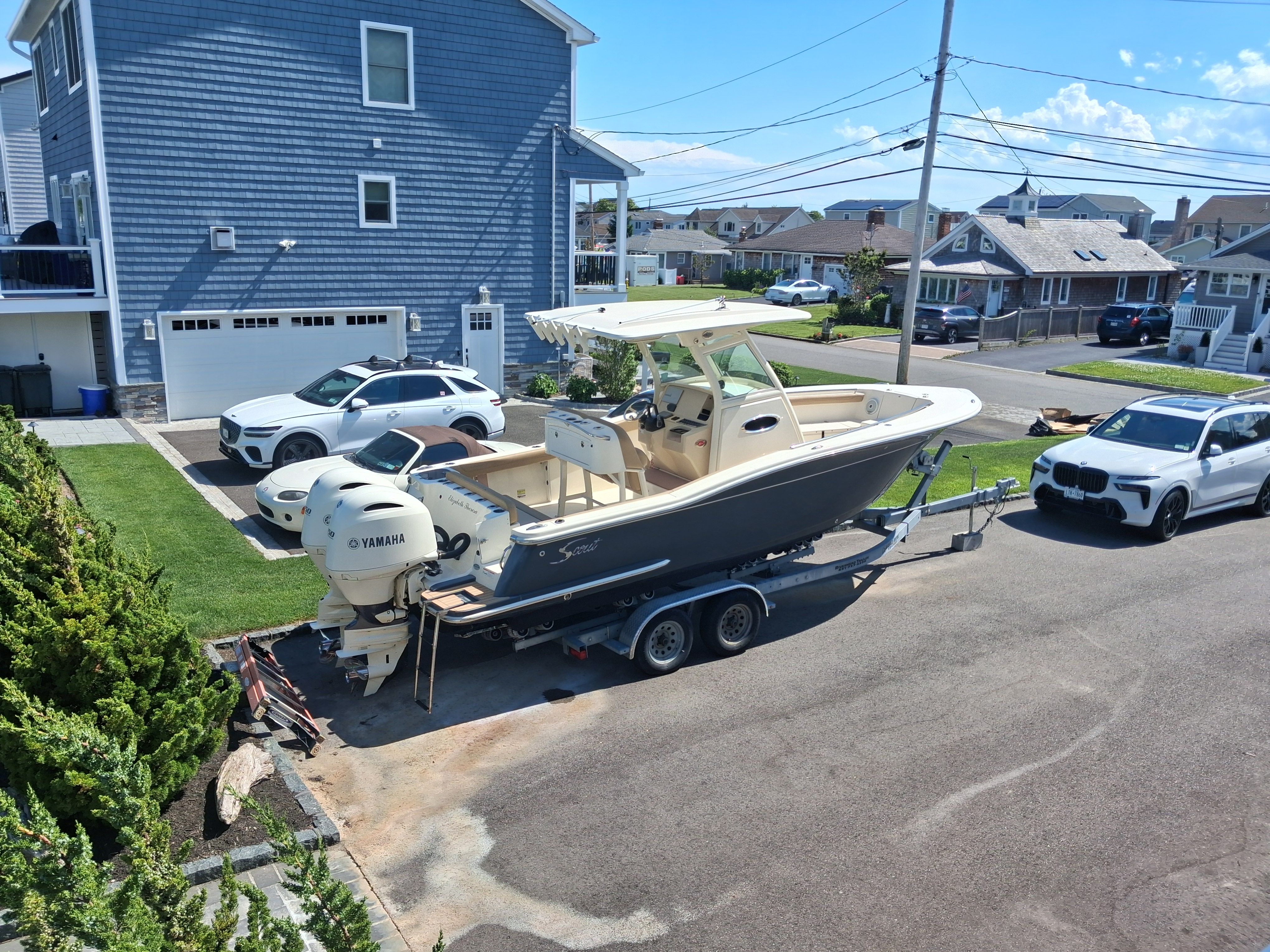 2018 Scout 255LXF boat on trailer in residential area.