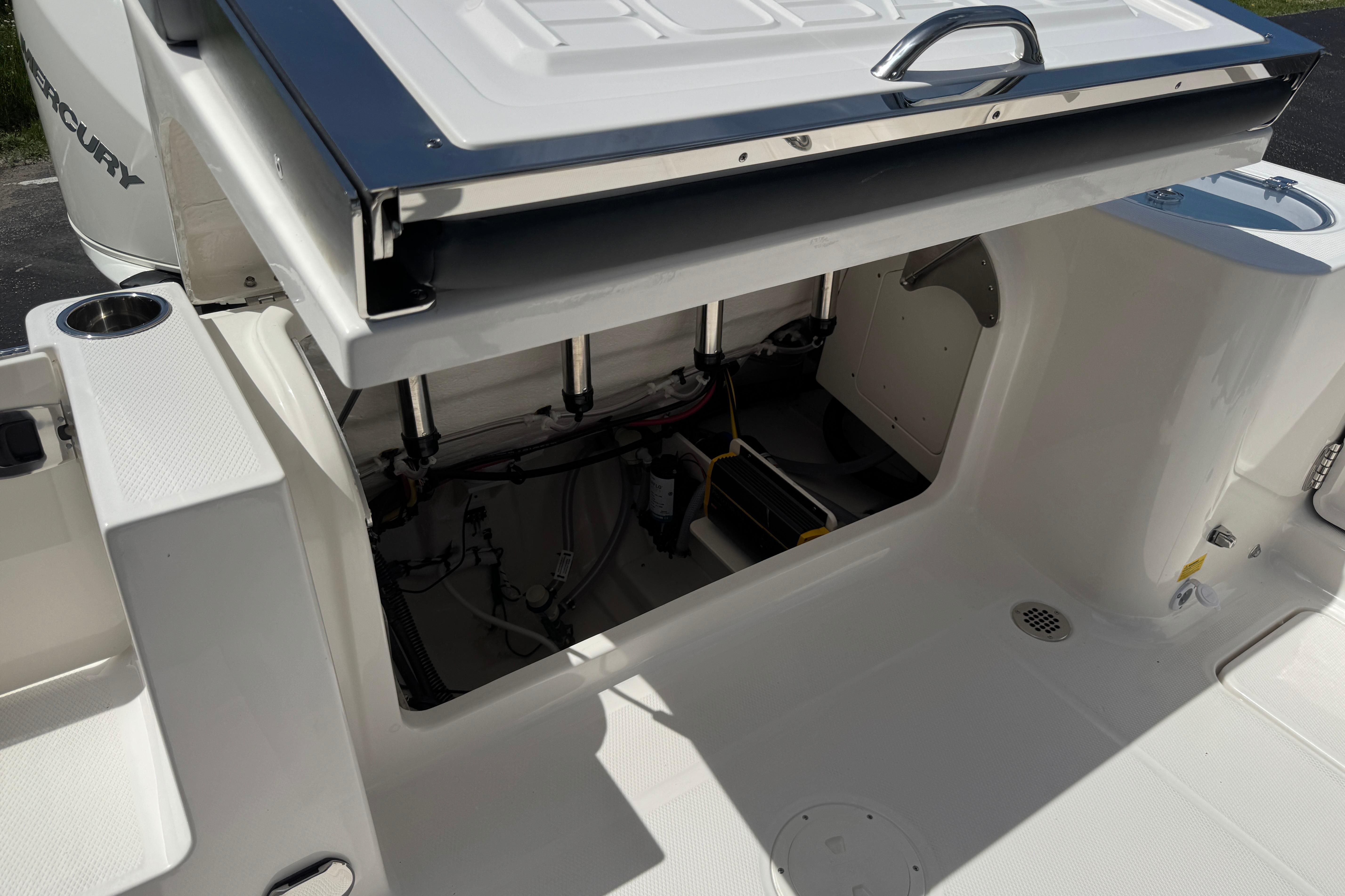 2026 Robalo R250 Center Console boat with open storage compartment, showcasing interior details.