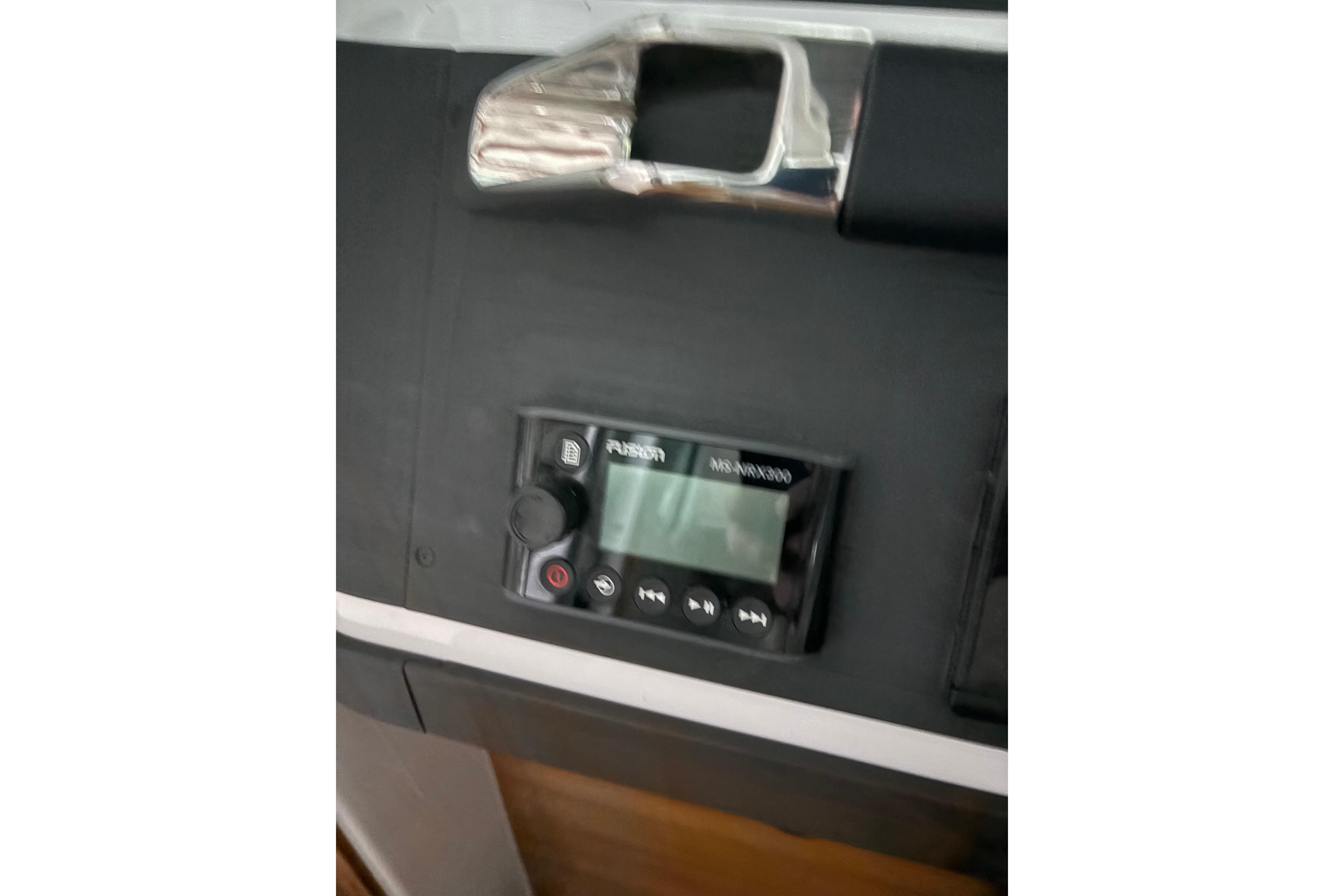 Control panel of 2022 Axopar 28 CABIN boat with Fusion MS-ARX200 stereo system.