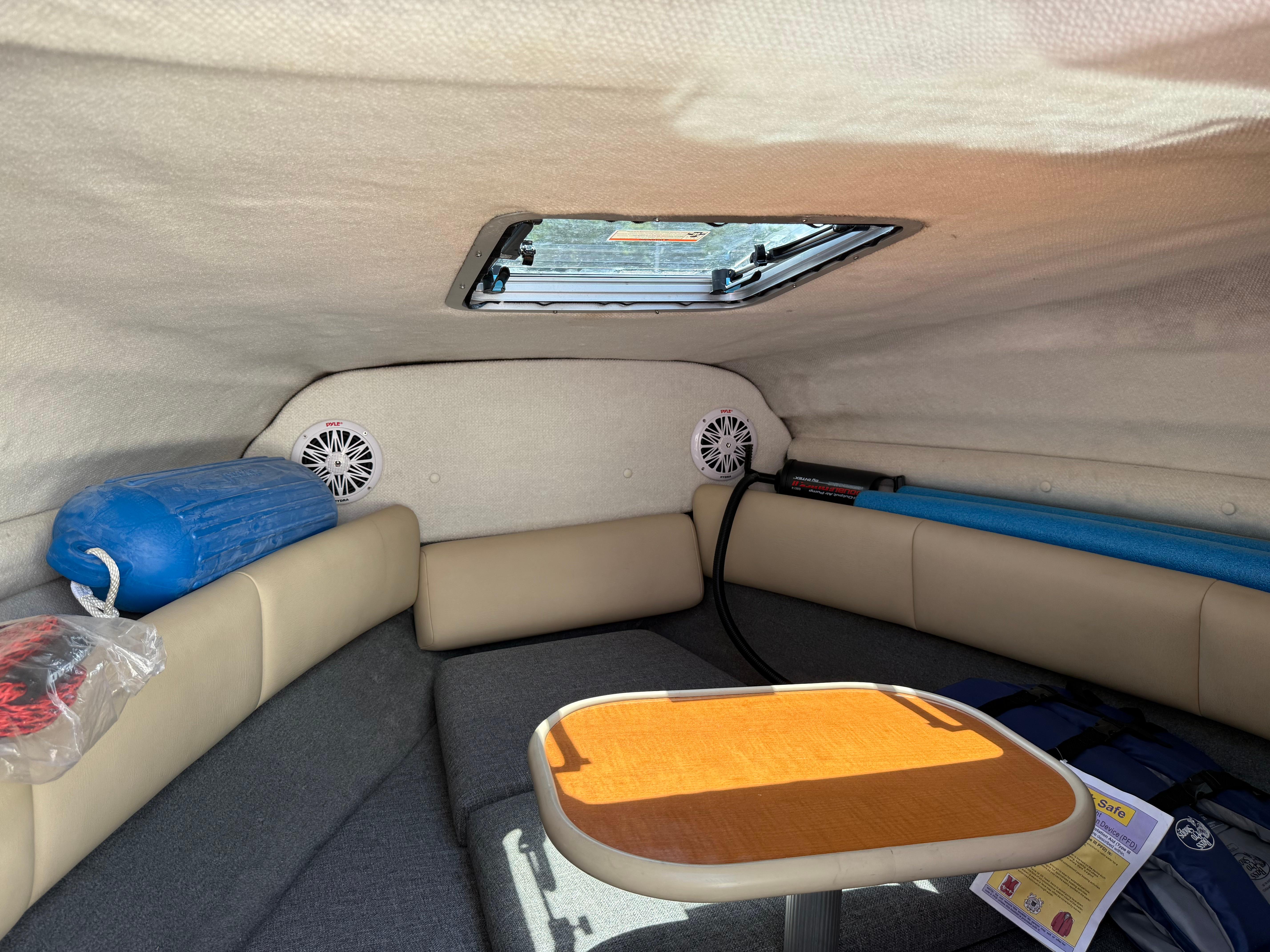 Interior cabin of 2007 Chaparral 215 SSi boat with seating and table.