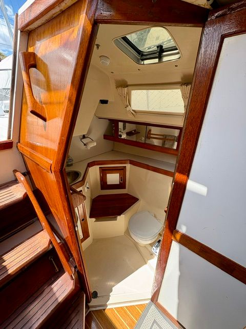 Interior of a 1989 Catalina 34 with wooden doors and a small bathroom.