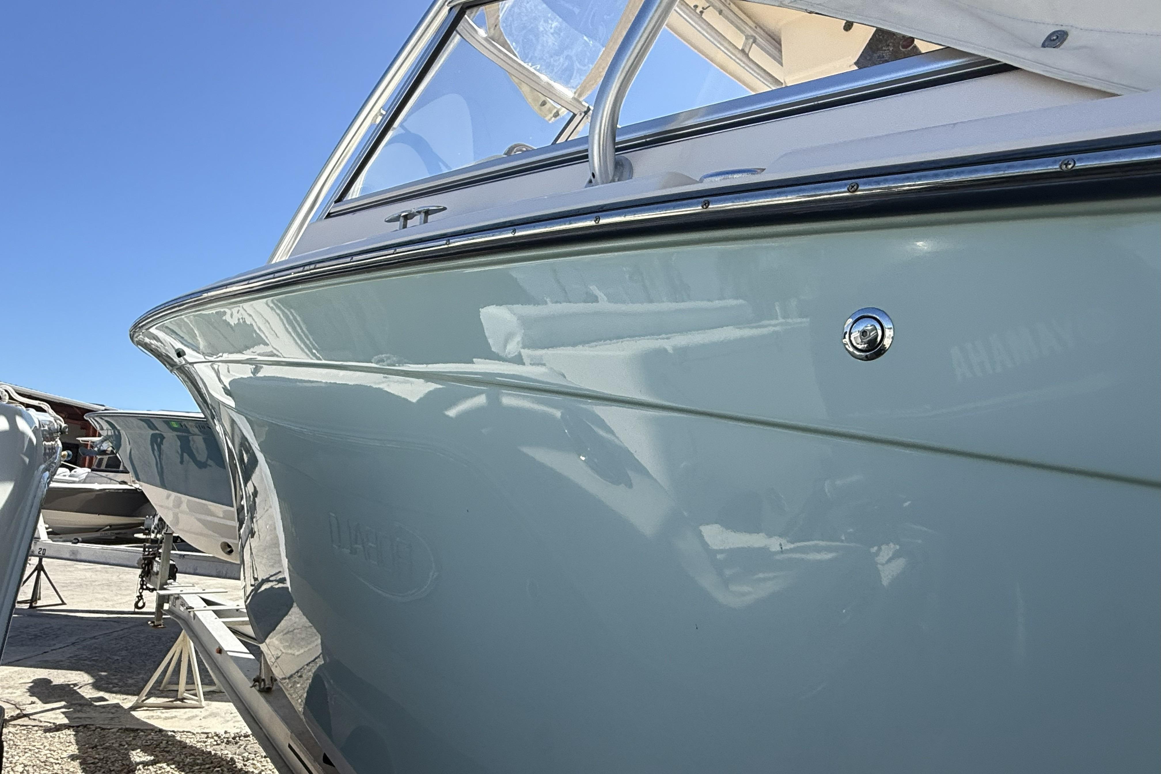 2014 Grady-White Freedom 275 boat, side view under clear blue sky.
