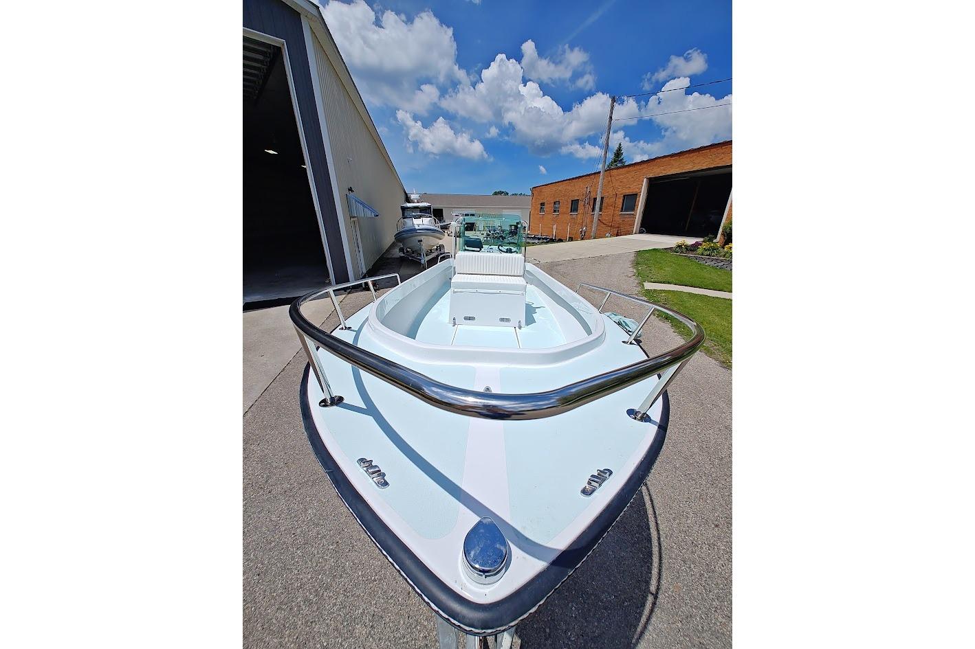 1975 Shamrock 200 Open boat, docked outdoors, under a clear blue sky.