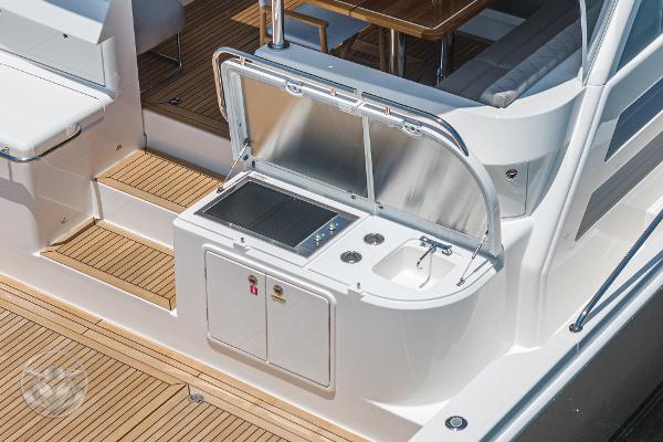 Outdoor kitchen on the 2025 Riviera 645 SUV yacht with sink and grill.