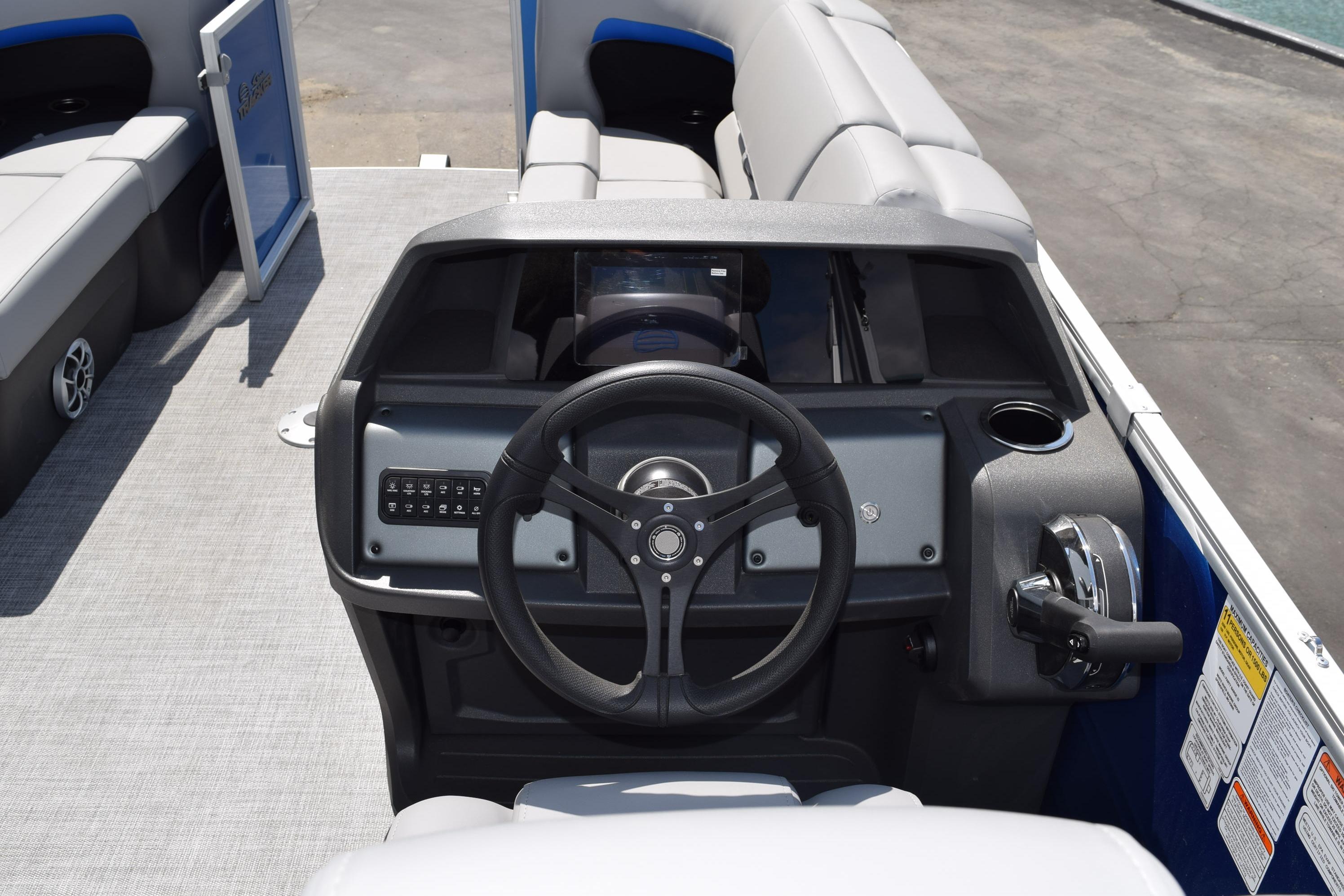2026 Sun Tracker Party Barge 22 RF DLX steering console with modern controls and seating.