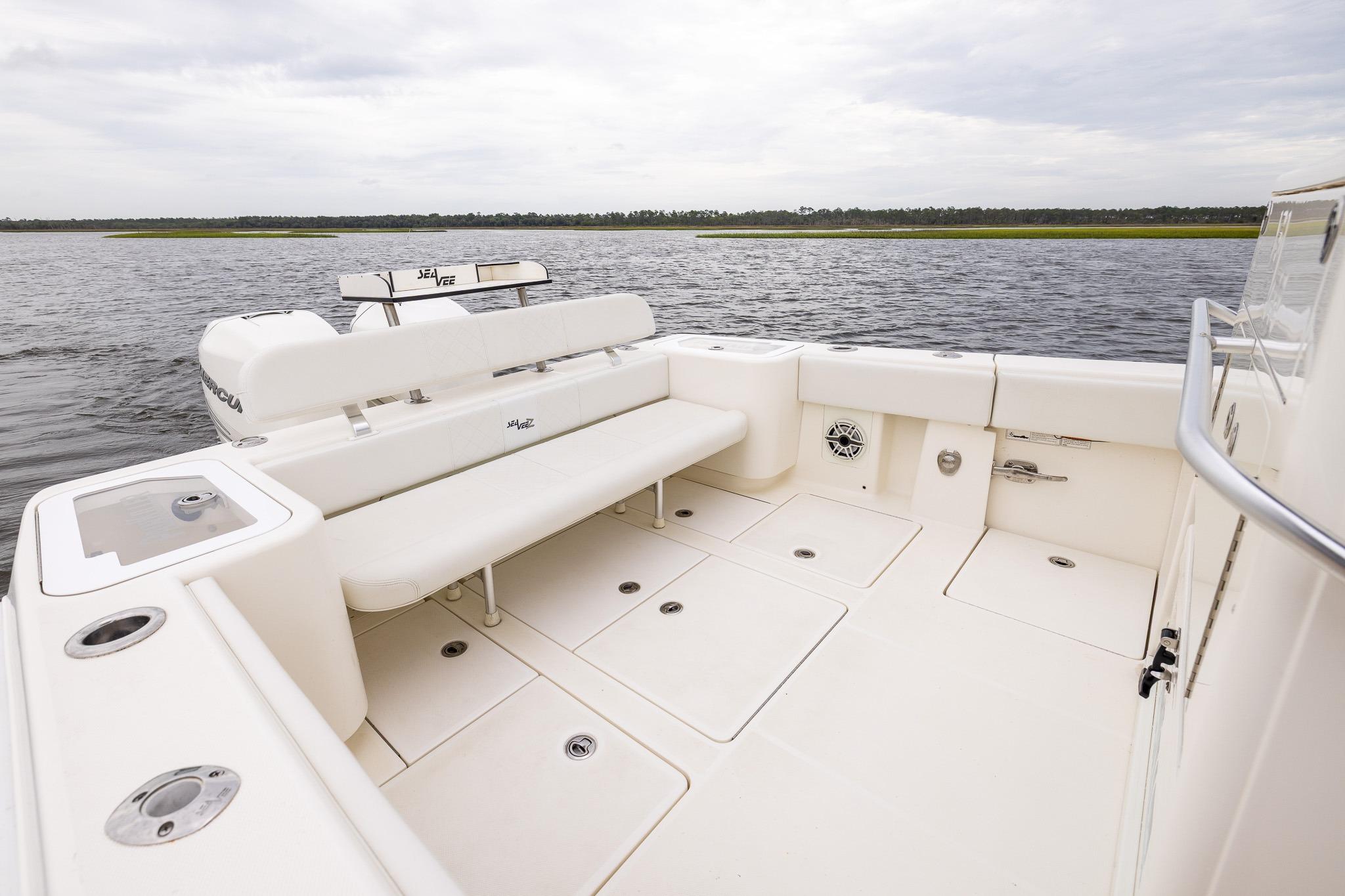 2019 SeaVee 322Z boat with spacious deck and seating, on calm waters.
