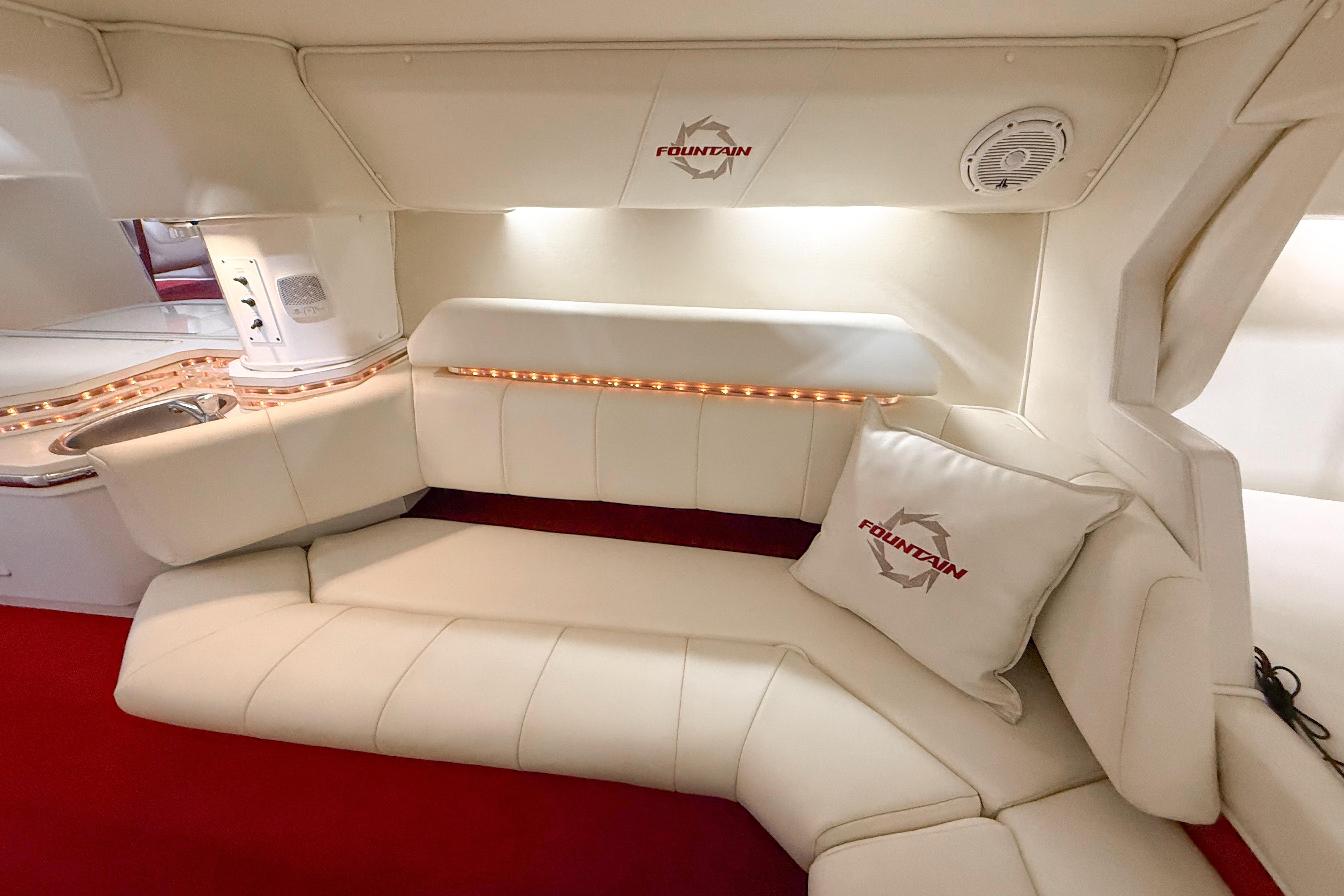 Luxurious interior of a 2007 Fountain 42 Lightning boat with plush seating and ambient lighting.