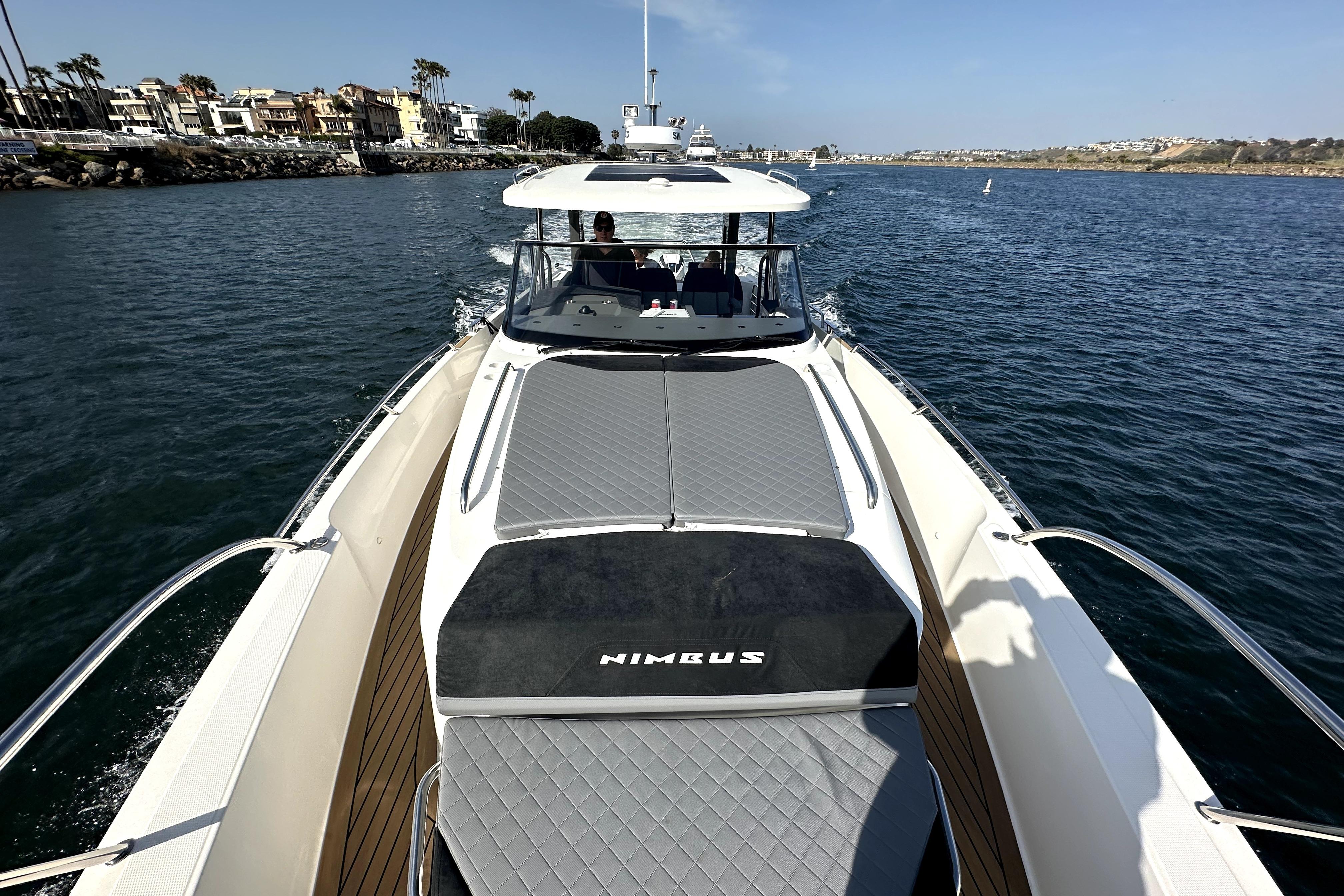 2023 Nimbus T11 yacht cruising on a sunny day, showcasing sleek design and luxury.