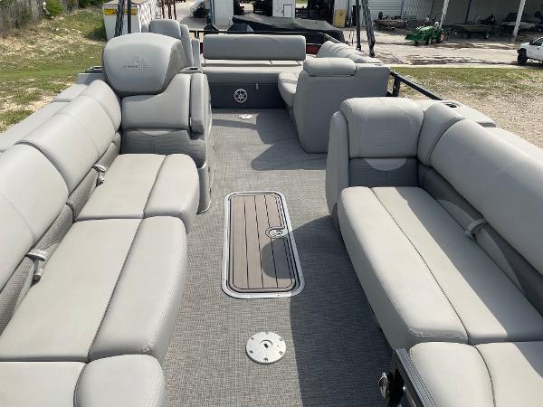 2023 Regency 250DL3 pontoon boat interior with spacious gray seating and deck.