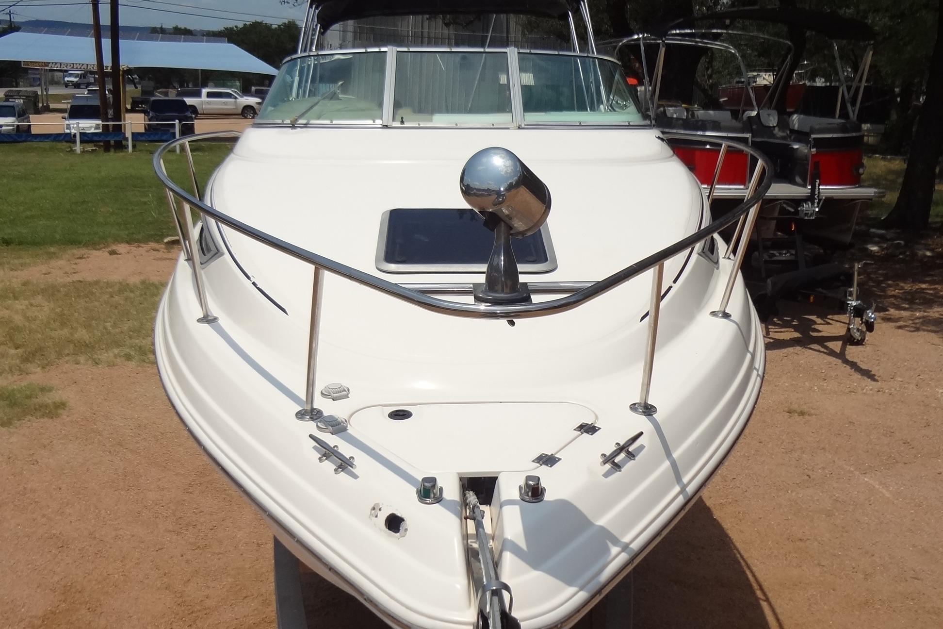2000 Chaparral Signature 260 boat, front view, parked on land, showcasing sleek design.