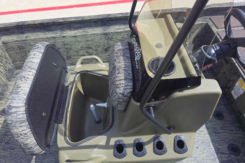 2026 Tracker Grizzly 1860 CC boat interior with open storage compartment and steering console.