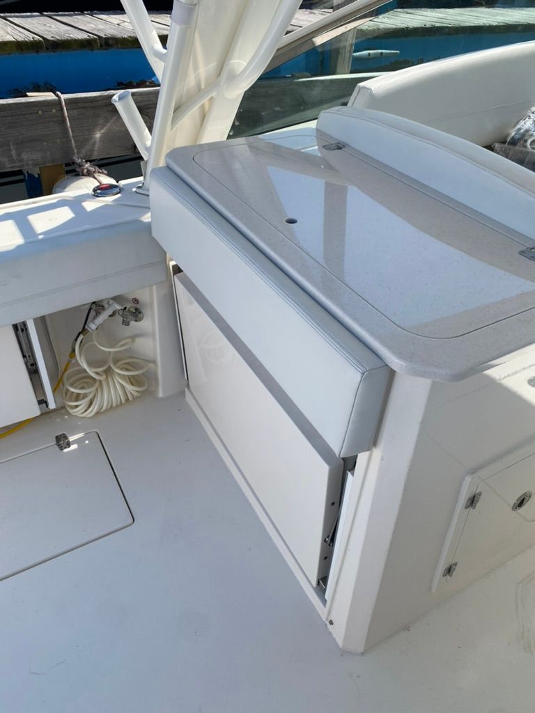 Interior of a 2023 Cobia 330 boat with storage area.