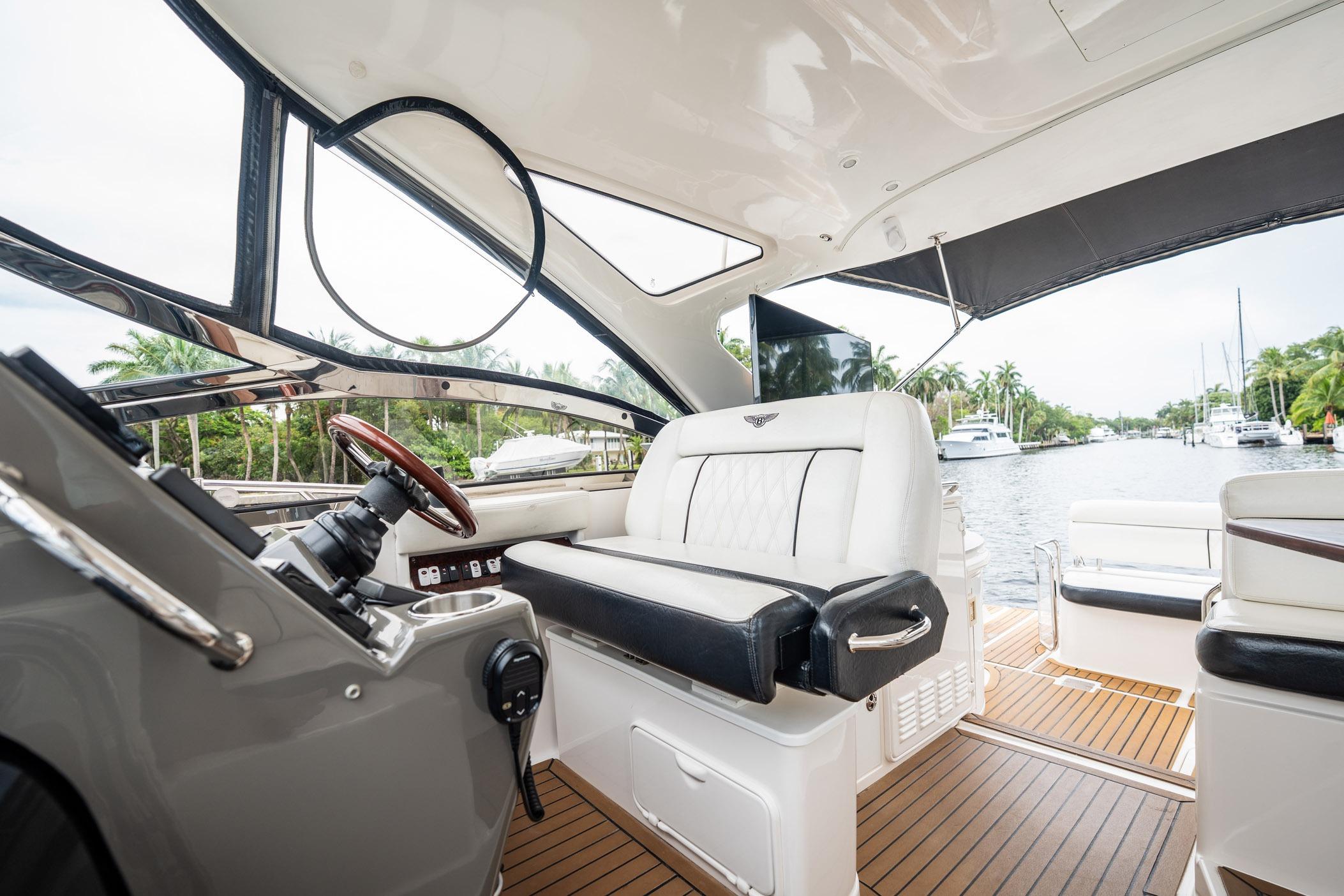 Luxurious interior of 2008 Regal Commodore 4460 yacht with elegant seating and scenic waterway view.