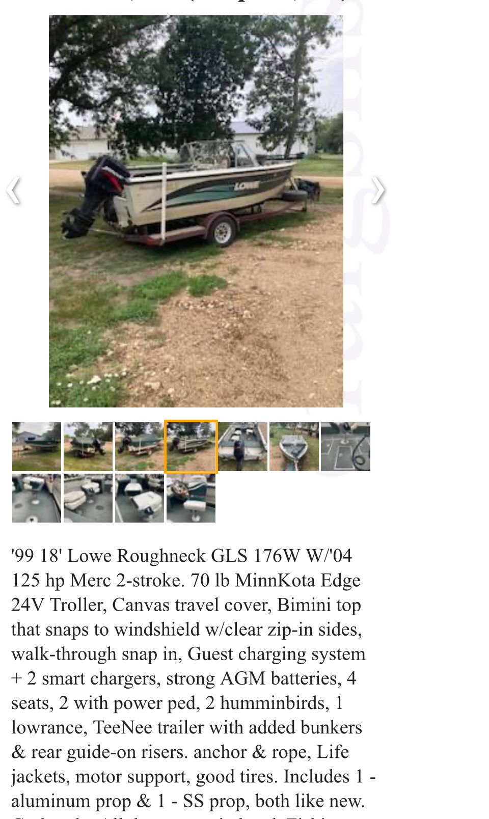 1999 Lowe Roughneck boat parked on trailer outdoors.