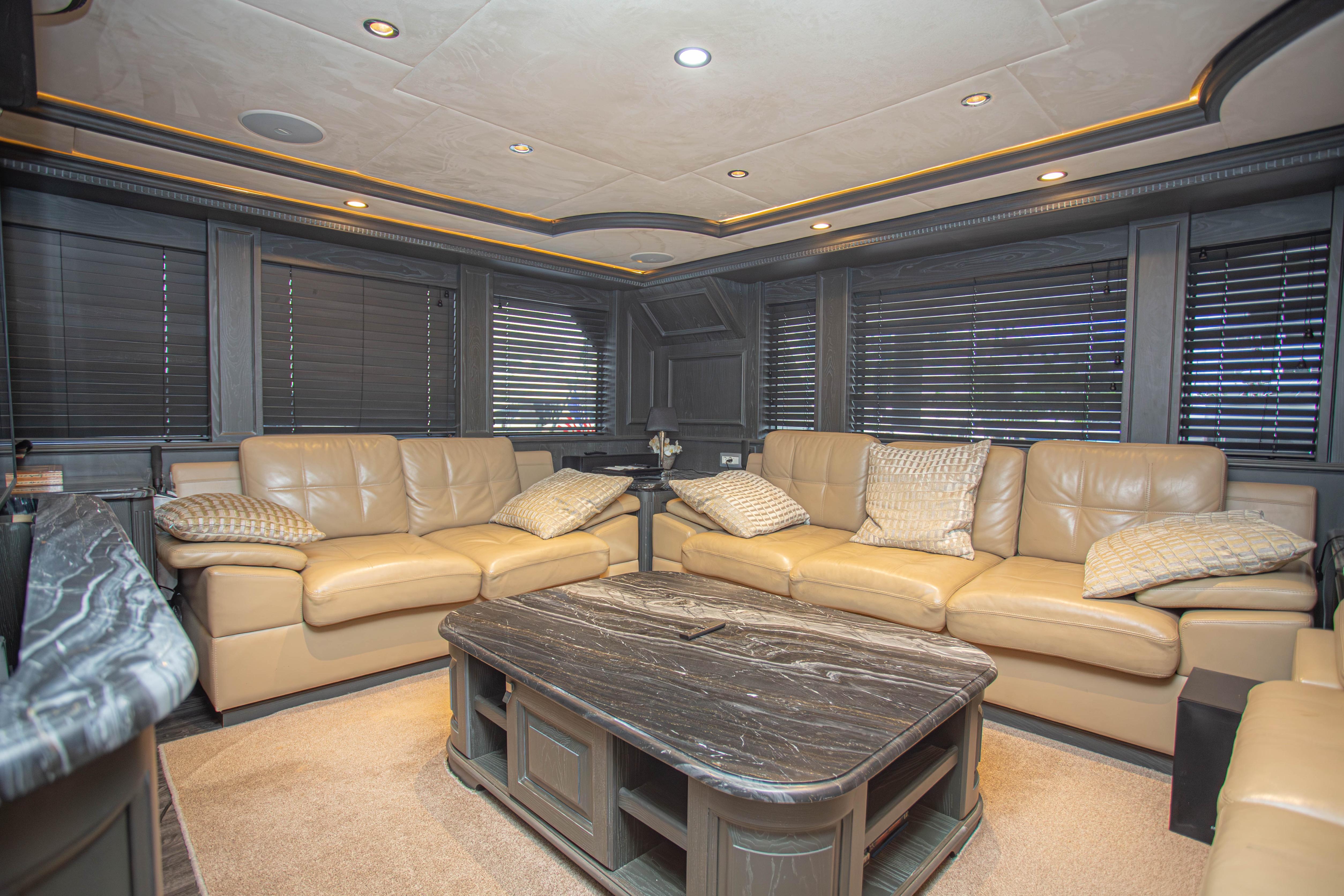Luxurious interior of 2014 Fifth Ocean Yachts 24m Explorer, featuring plush leather seating and elegant decor.