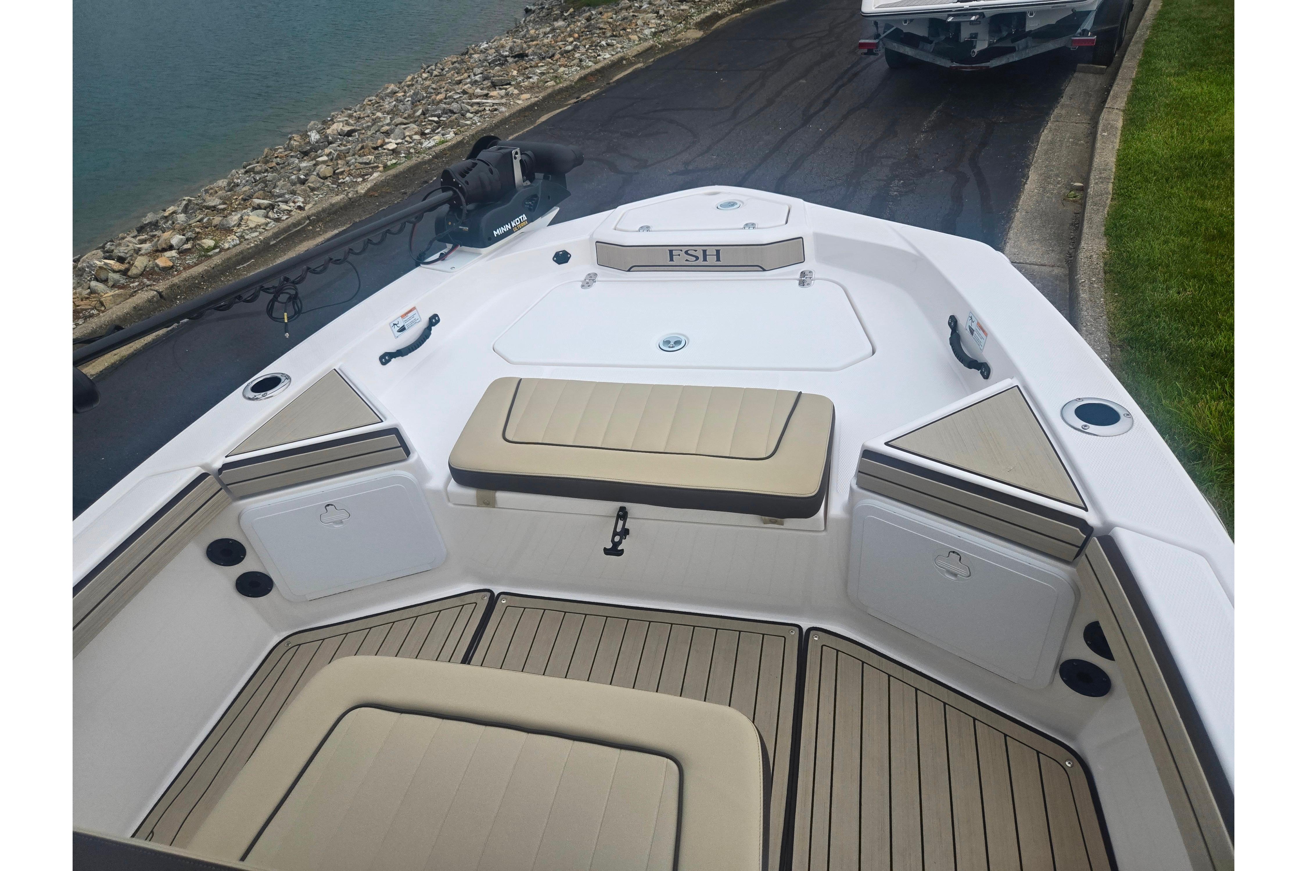 2022 Yamaha Boats 195 FSH Sport interior with seating and storage compartments.