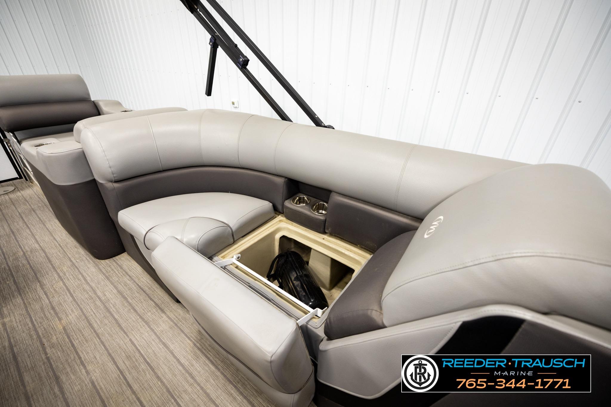 2019 Manitou Oasis SR VP pontoon boat interior with storage compartment and plush seating.