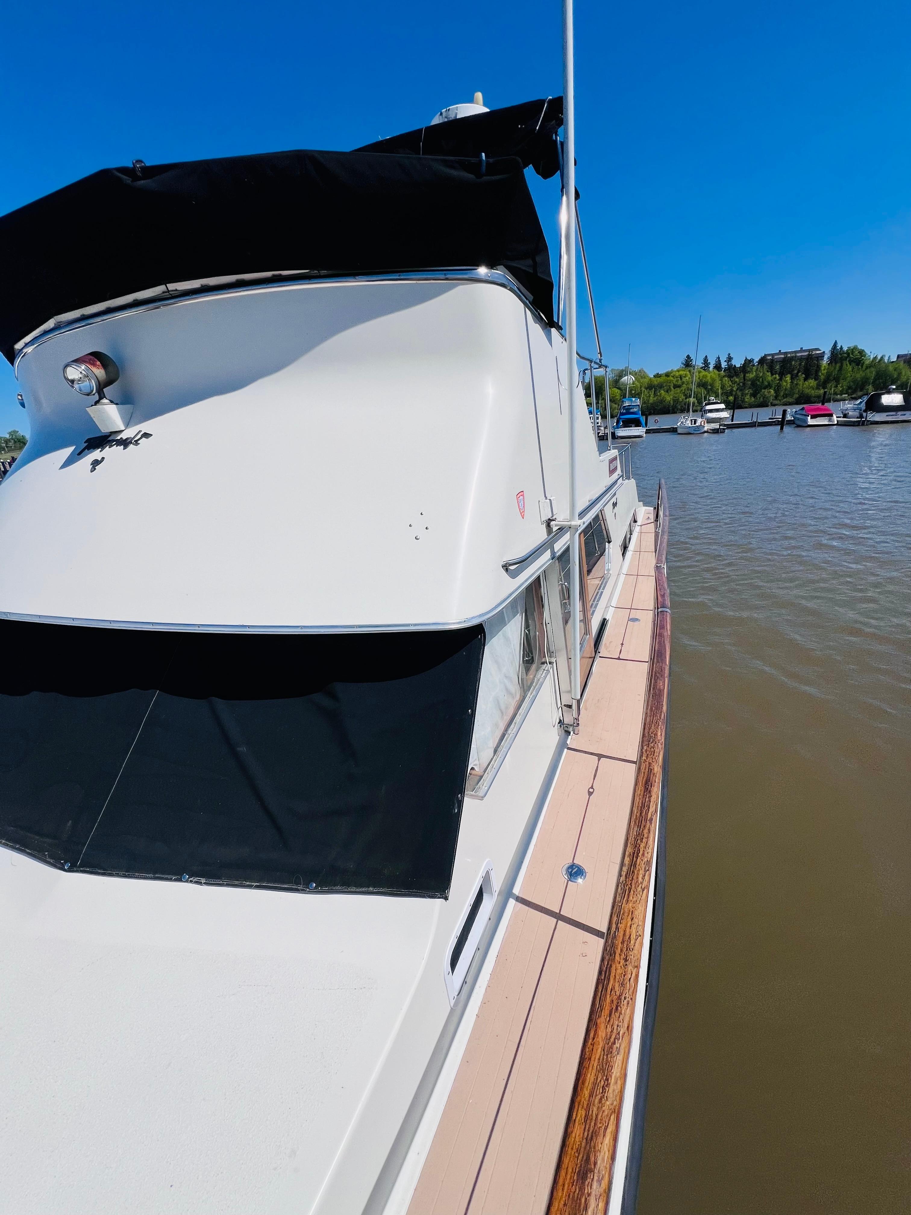 1974 Tollycraft 40 Tri-Cabin Motoryacht docked on a sunny day.