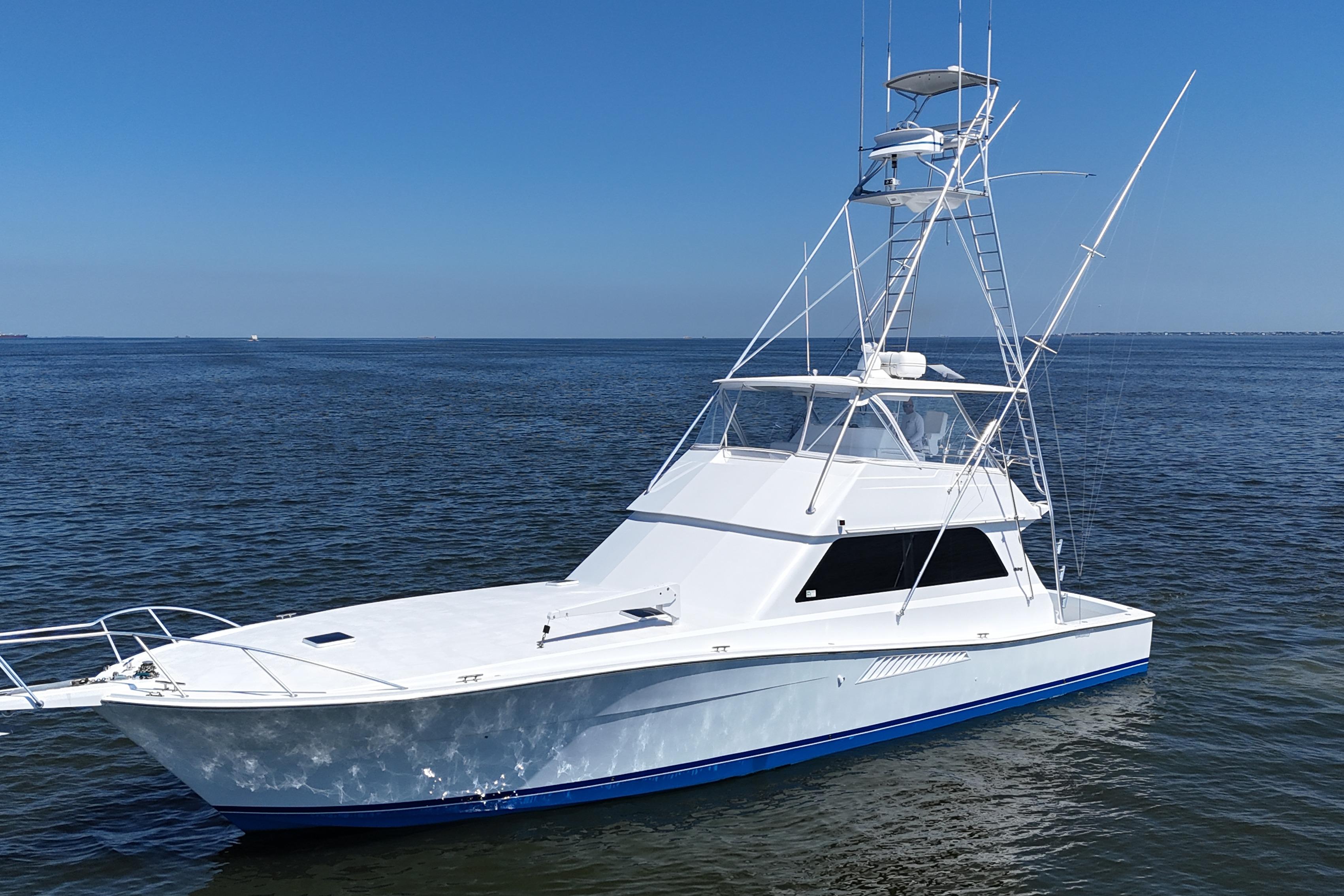 1997 Viking 58 Convertible yacht on calm ocean waters under clear blue sky.
