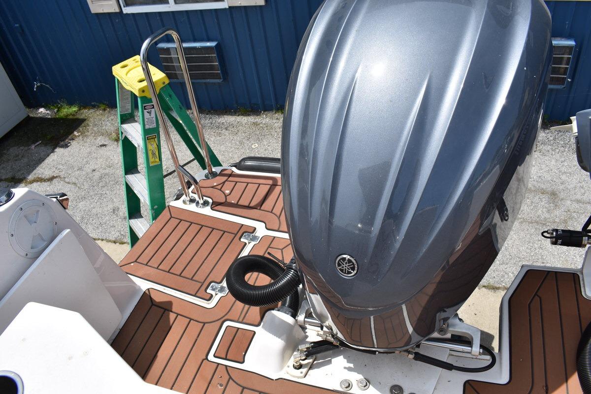 2024 Ranger Tugs R-25 boat with Yamaha outboard motor and teak deck.