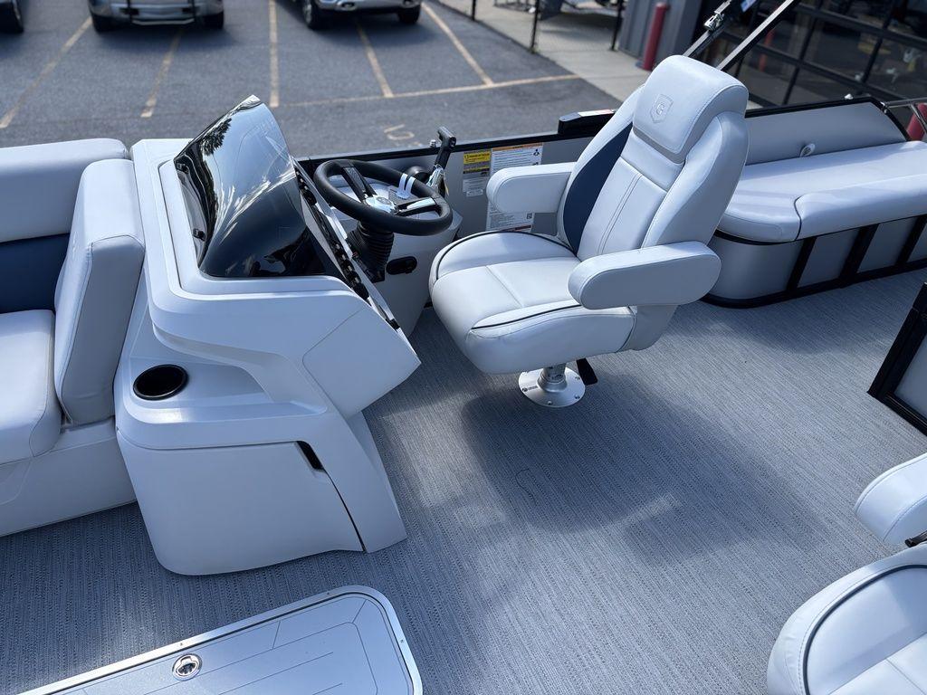 2026 Godfrey SWEETWATER 2286 SFL boat interior with captain's chair and steering console.