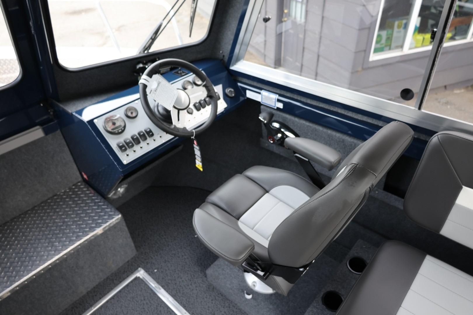 Interior of 2026 Thunder Jet 24 Alexis Pro boat, featuring steering wheel and control panel.