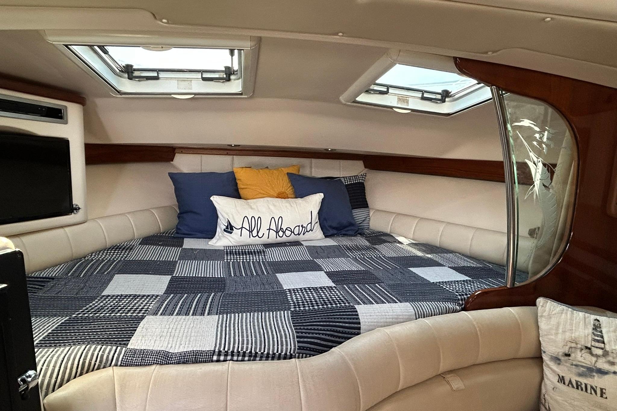 Cozy cabin interior of 2007 Grady-White Express 360 with nautical decor and skylights.