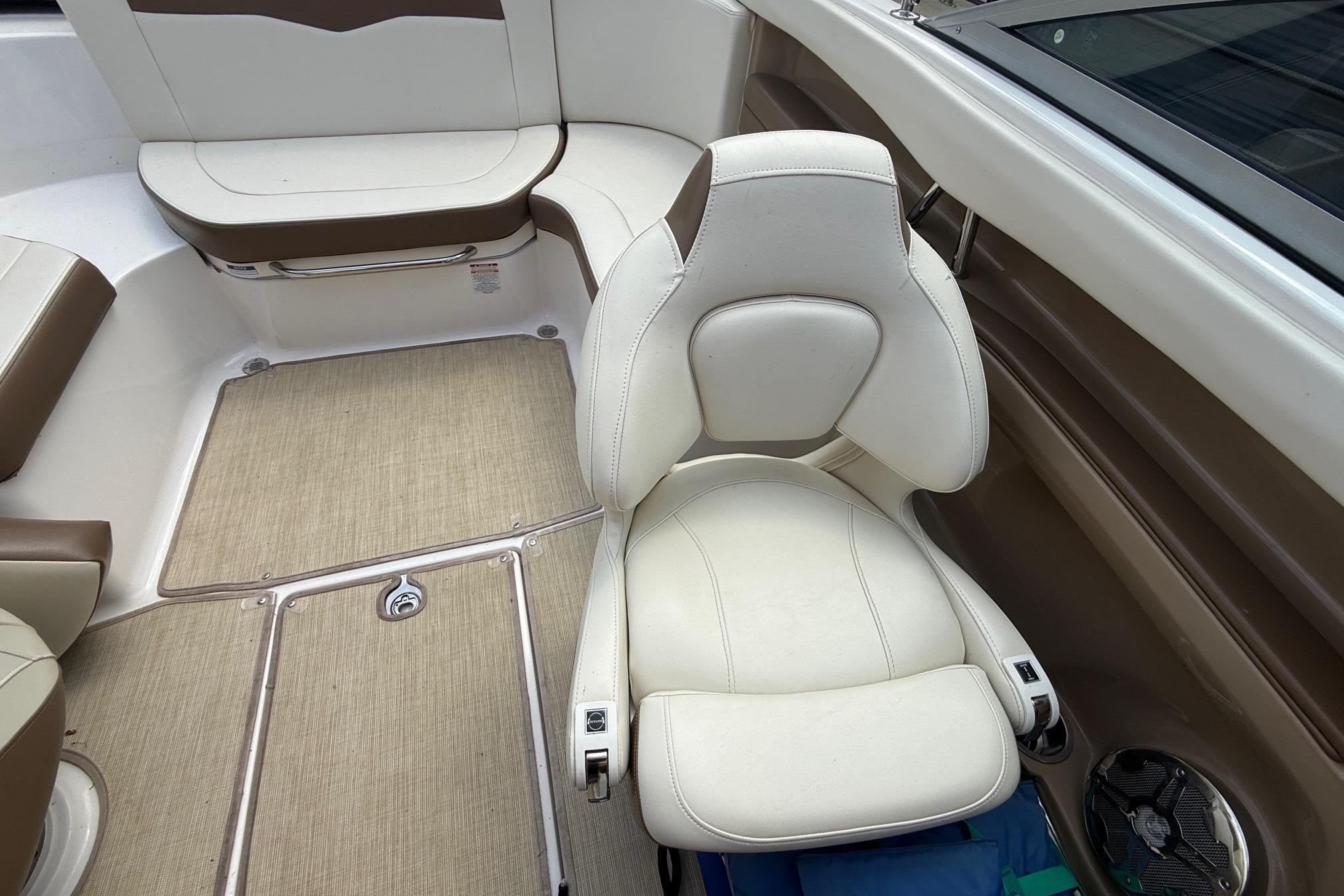 Interior of 2016 Chaparral 226 SSi Wide Tech boat with beige seating and carpet.