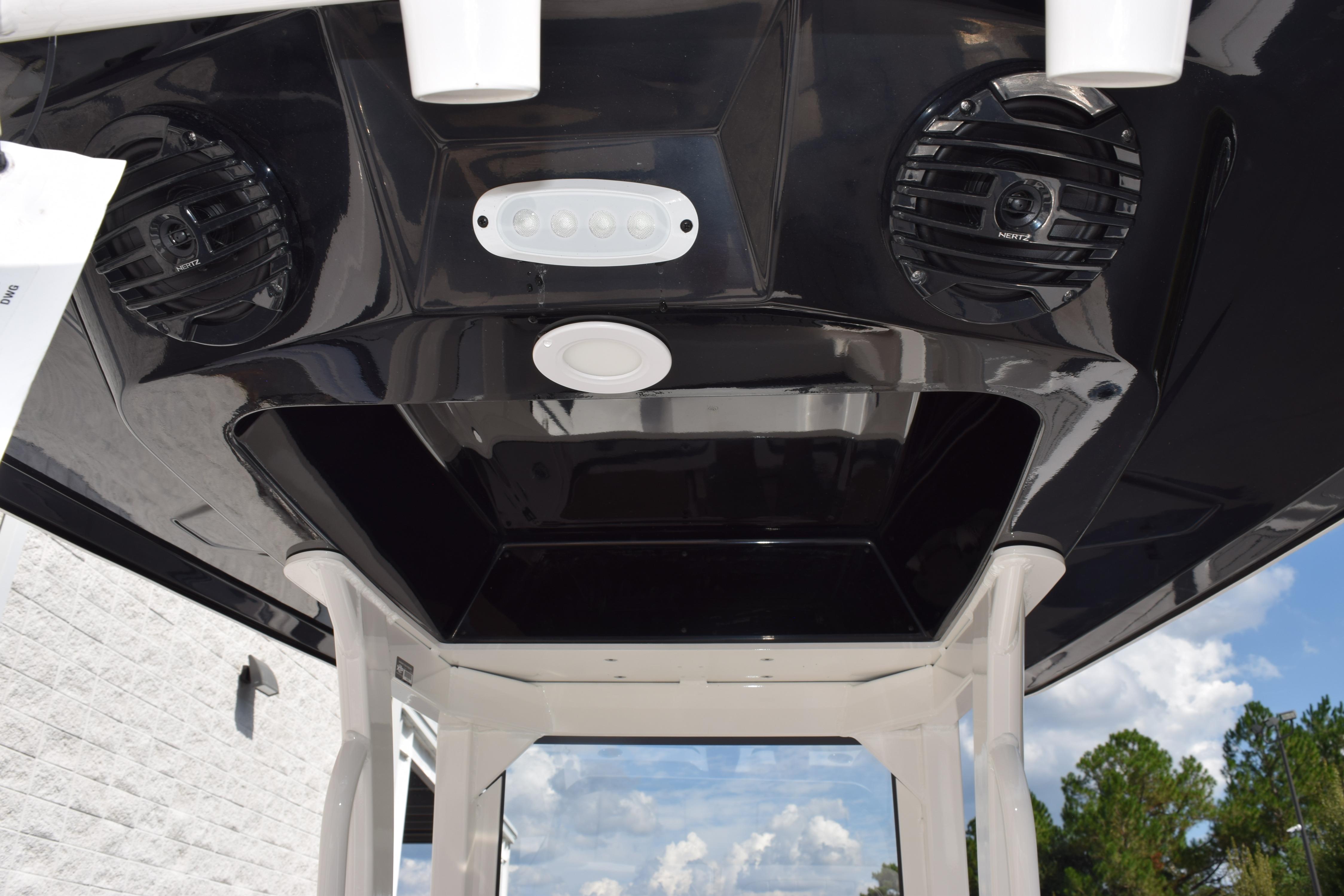 2026 Yamaha Boats 255 FSH Sport H T-top with speakers and lighting.