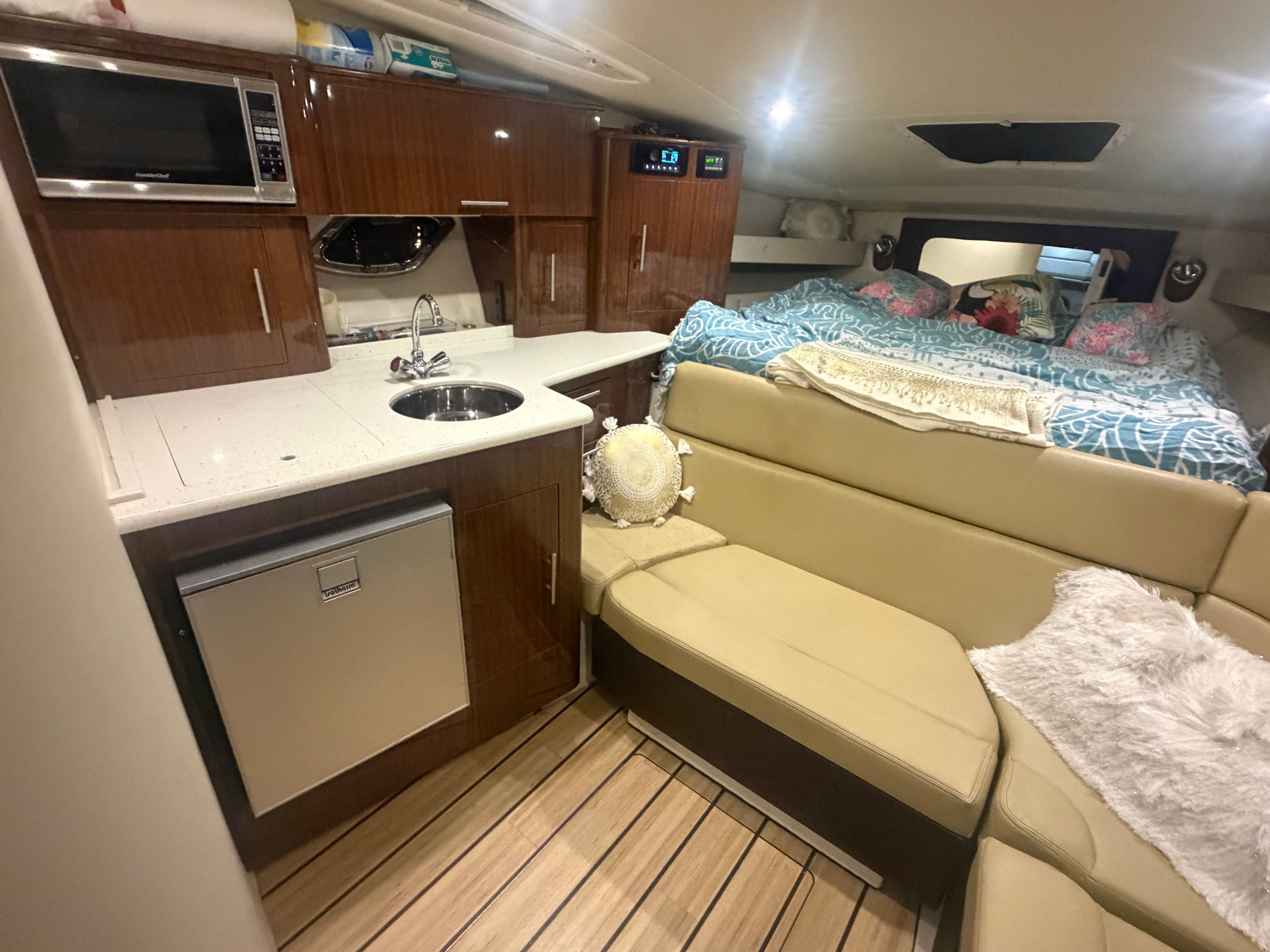Interior of 2015 Regal 35 Sport Coupe with kitchen and sleeping area.