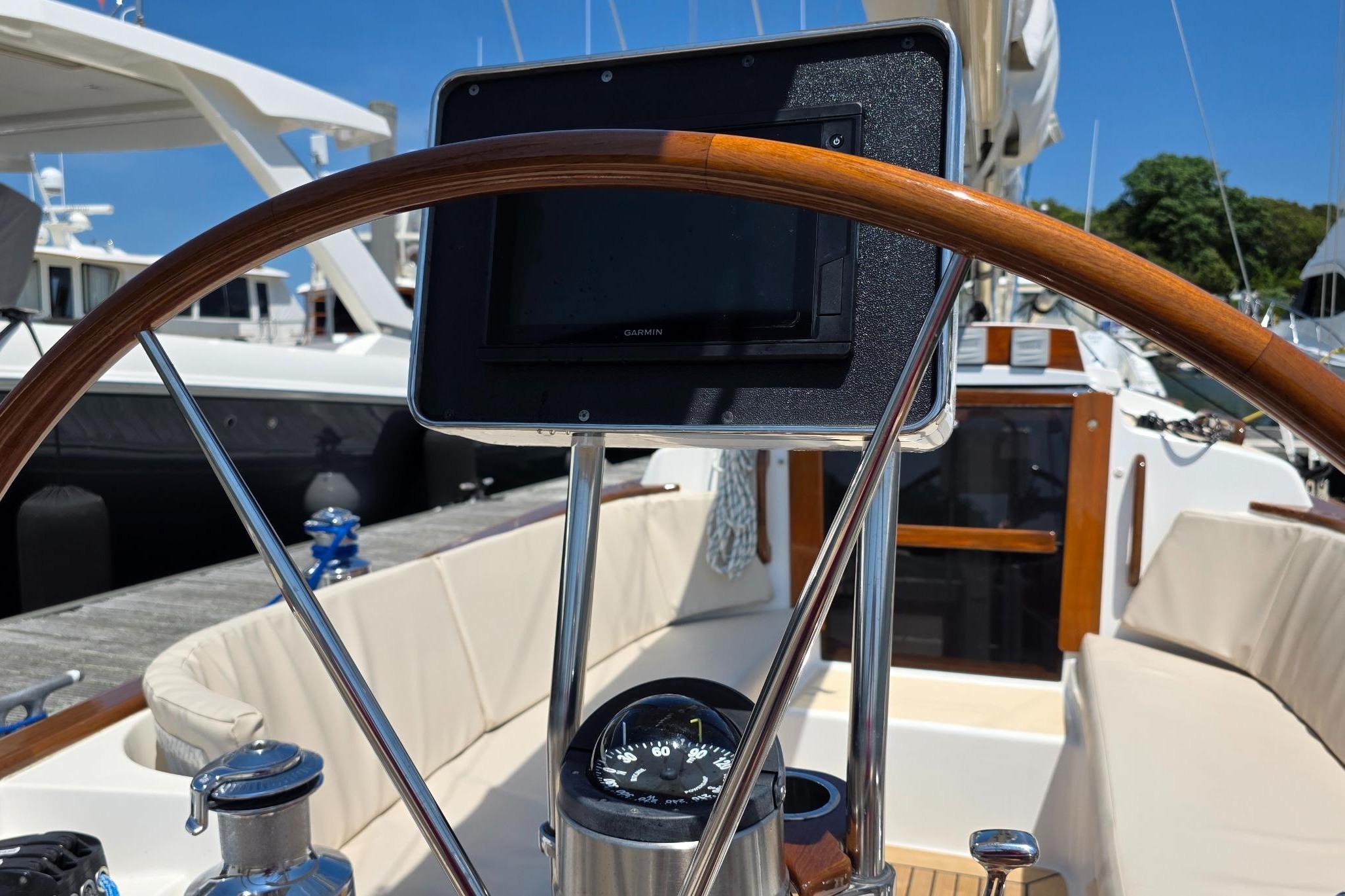 Cockpit of 2020 Alerion Express 33 sailboat with wooden wheel and navigation instruments.
