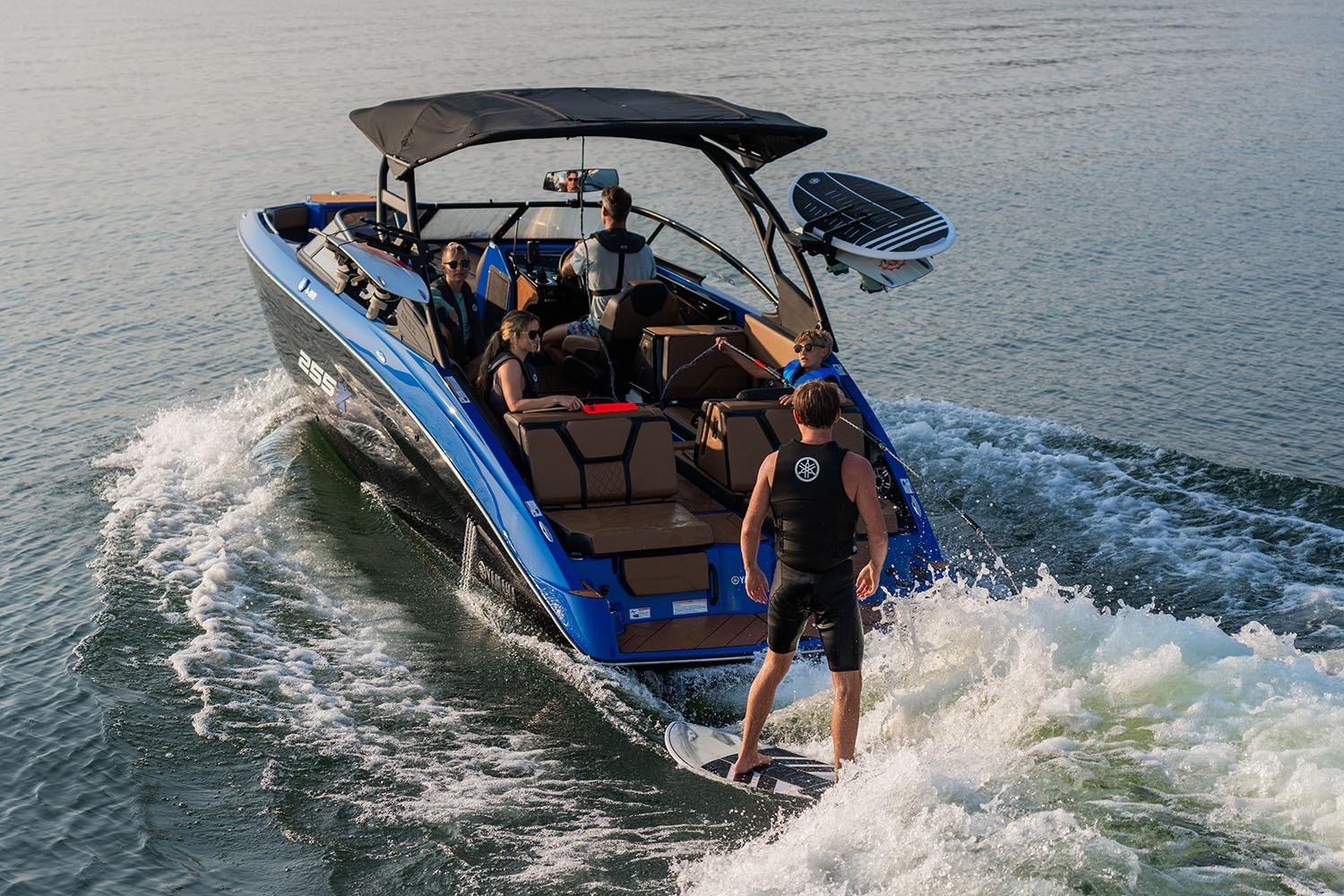 Manufacturer Provided Image: 2026 Yamaha Boats 255XD with passengers and wakeboarder on a sunny day.