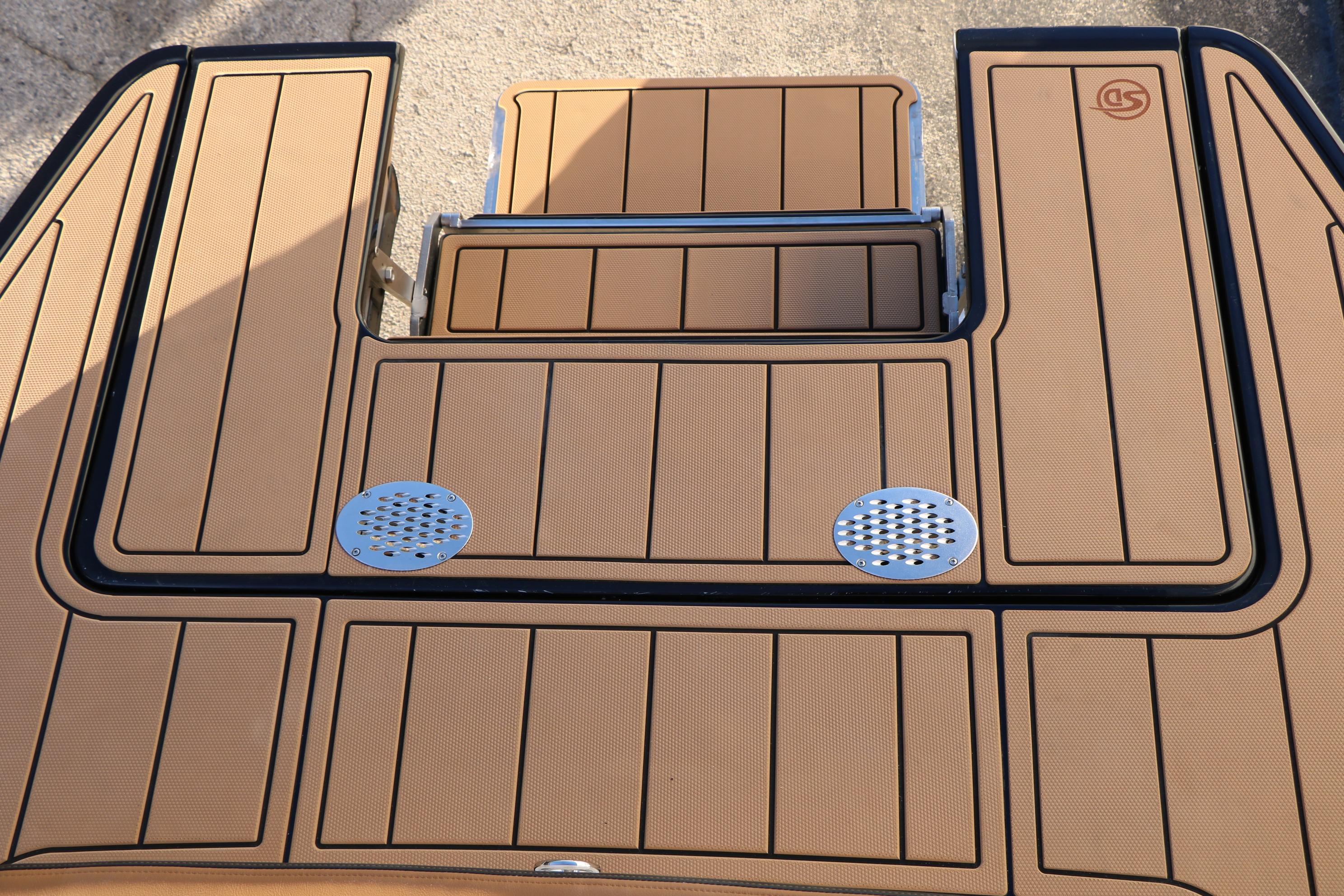 2026 Chaparral 247 SSX boat deck with tan non-slip surface and metal accents.