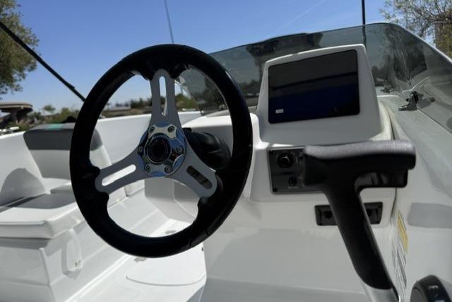 Steering wheel and dashboard of 2026 Tahoe T18 boat, featuring modern controls.