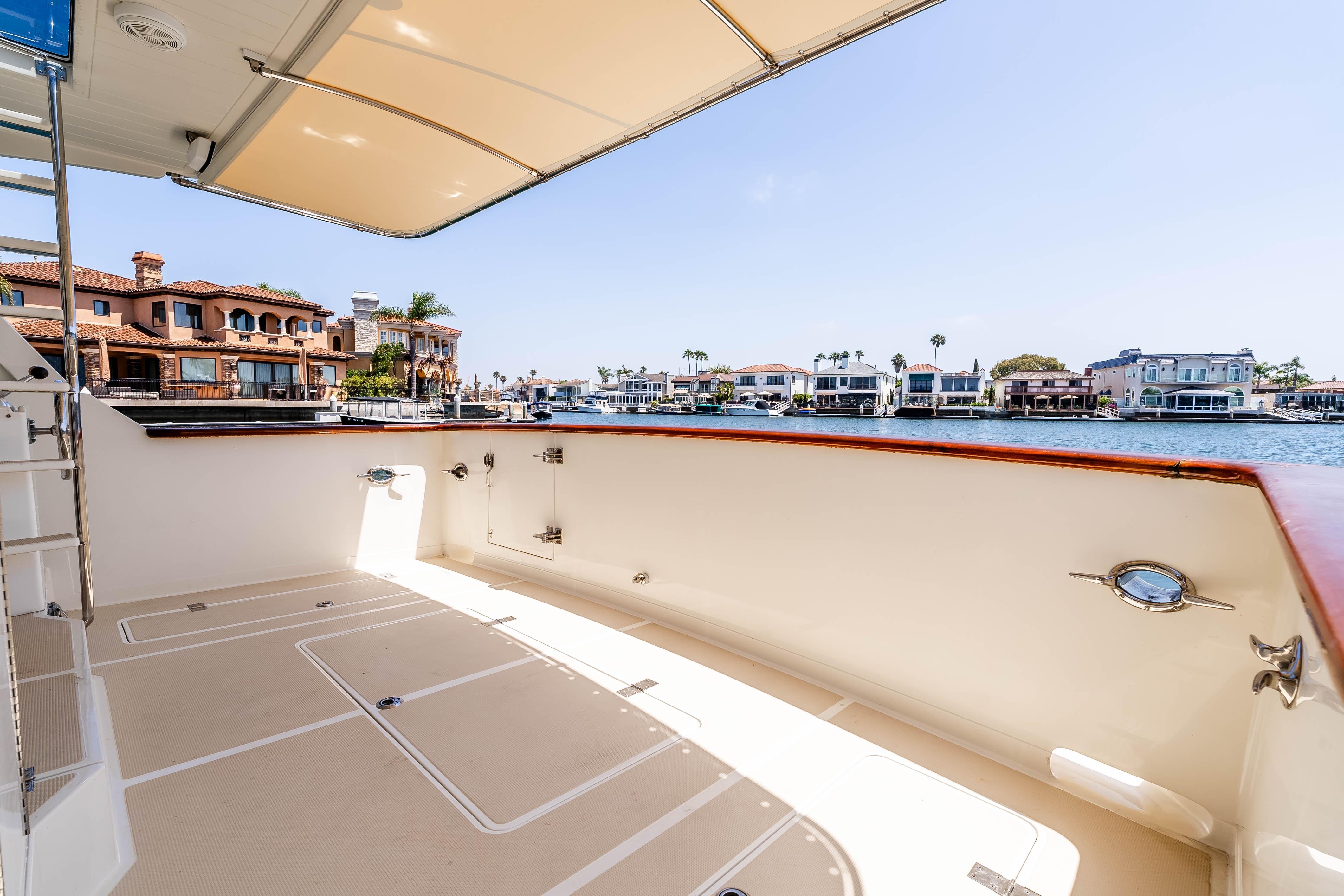 Spacious deck of 2005 Offshore Yachts 54 Pilothouse with waterfront view.