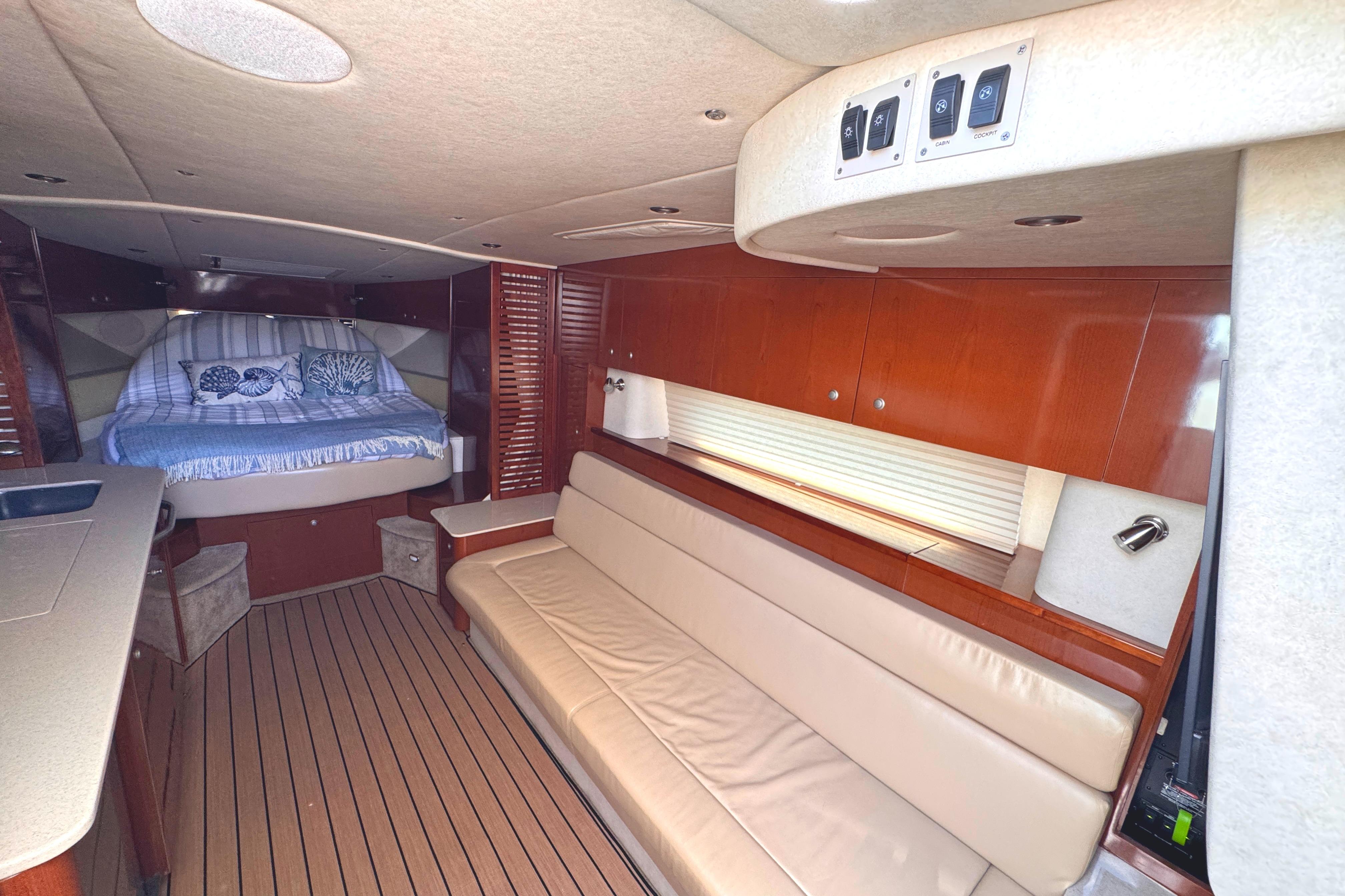Luxurious interior of 2008 Sea Ray Sundancer 350 with cozy bed and elegant seating.