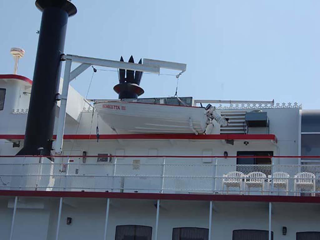 A 1985 Custom Serodino Dinner Boat with lifeboat and deck seating.