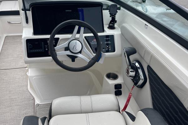 2023 Sea Ray SPX 230 boat cockpit with steering wheel and control panel.
