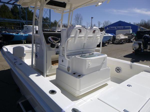 2024 Ranger 2360 Bay boat interior with seating and console, parked outdoors.