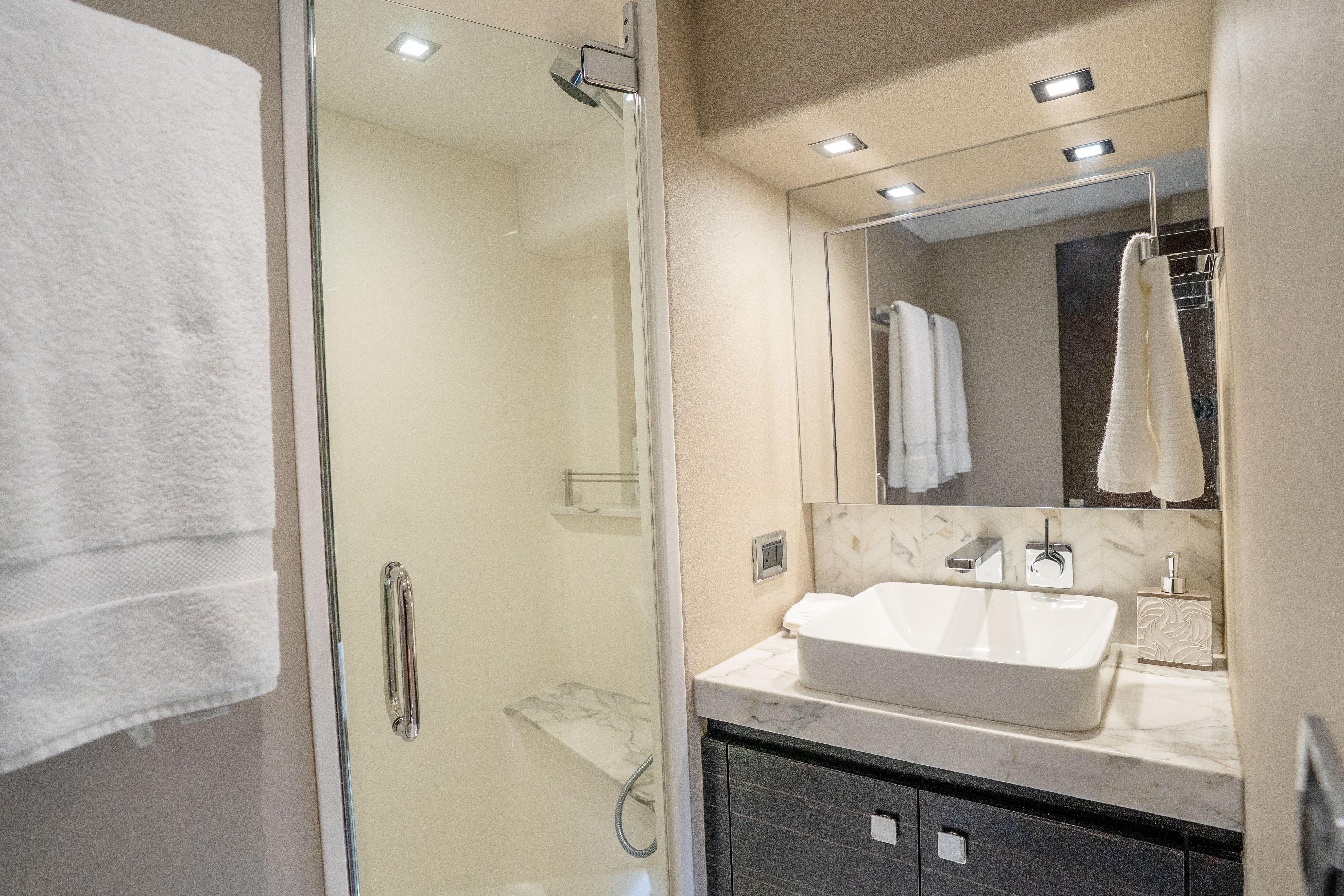 Luxurious bathroom in 2021 Hatteras M75 Panacera yacht with modern fixtures and elegant design.
