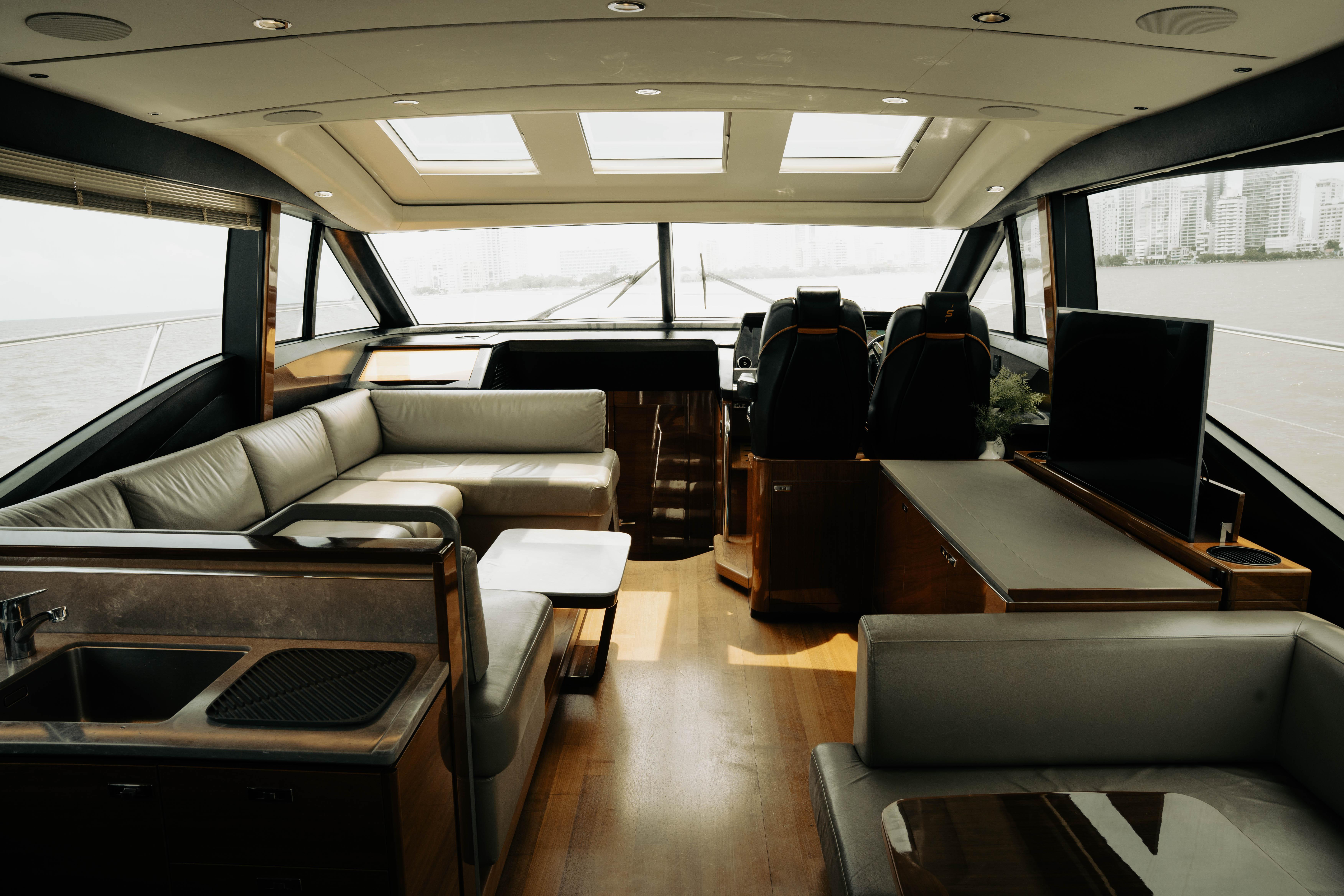 Luxurious interior of 2020 Princess S62 yacht with modern seating and panoramic windows.