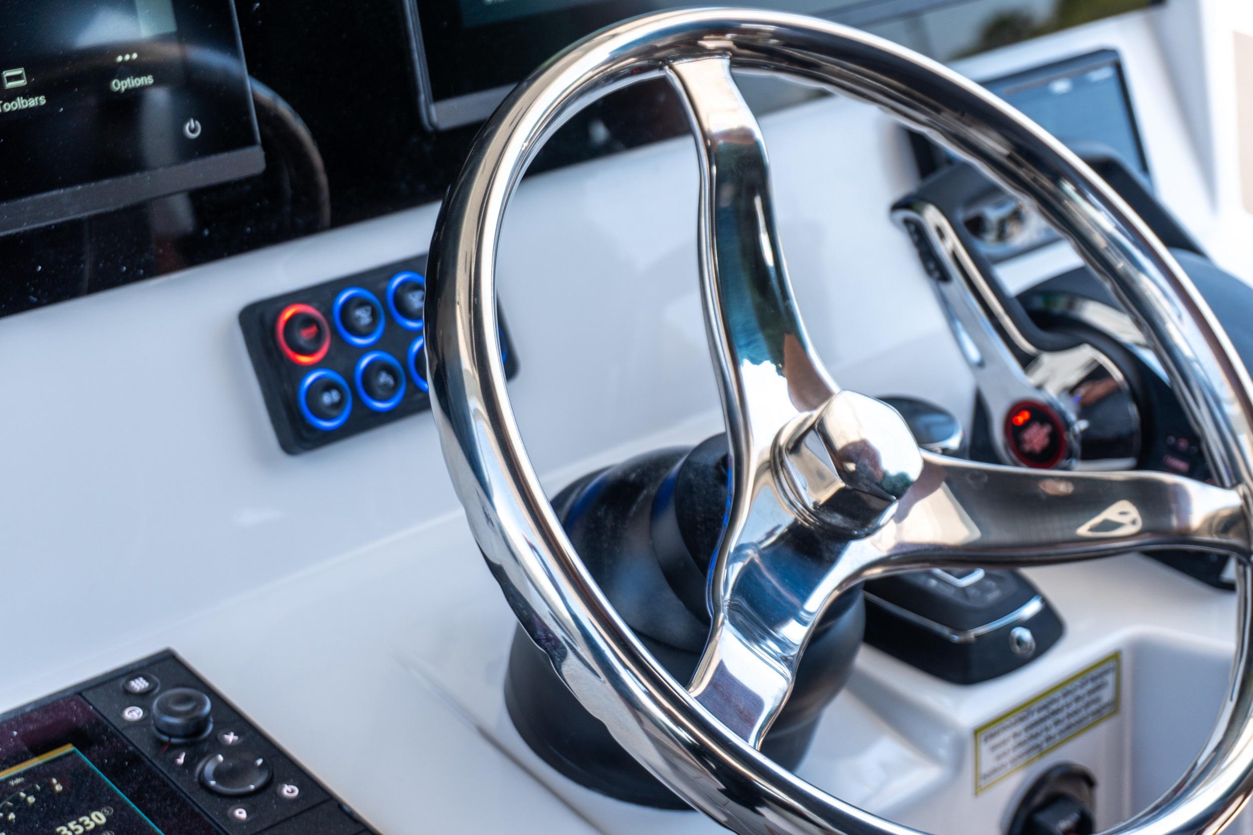 Steering wheel of 2026 Twin Vee 400 GFX2 CC boat with modern controls.